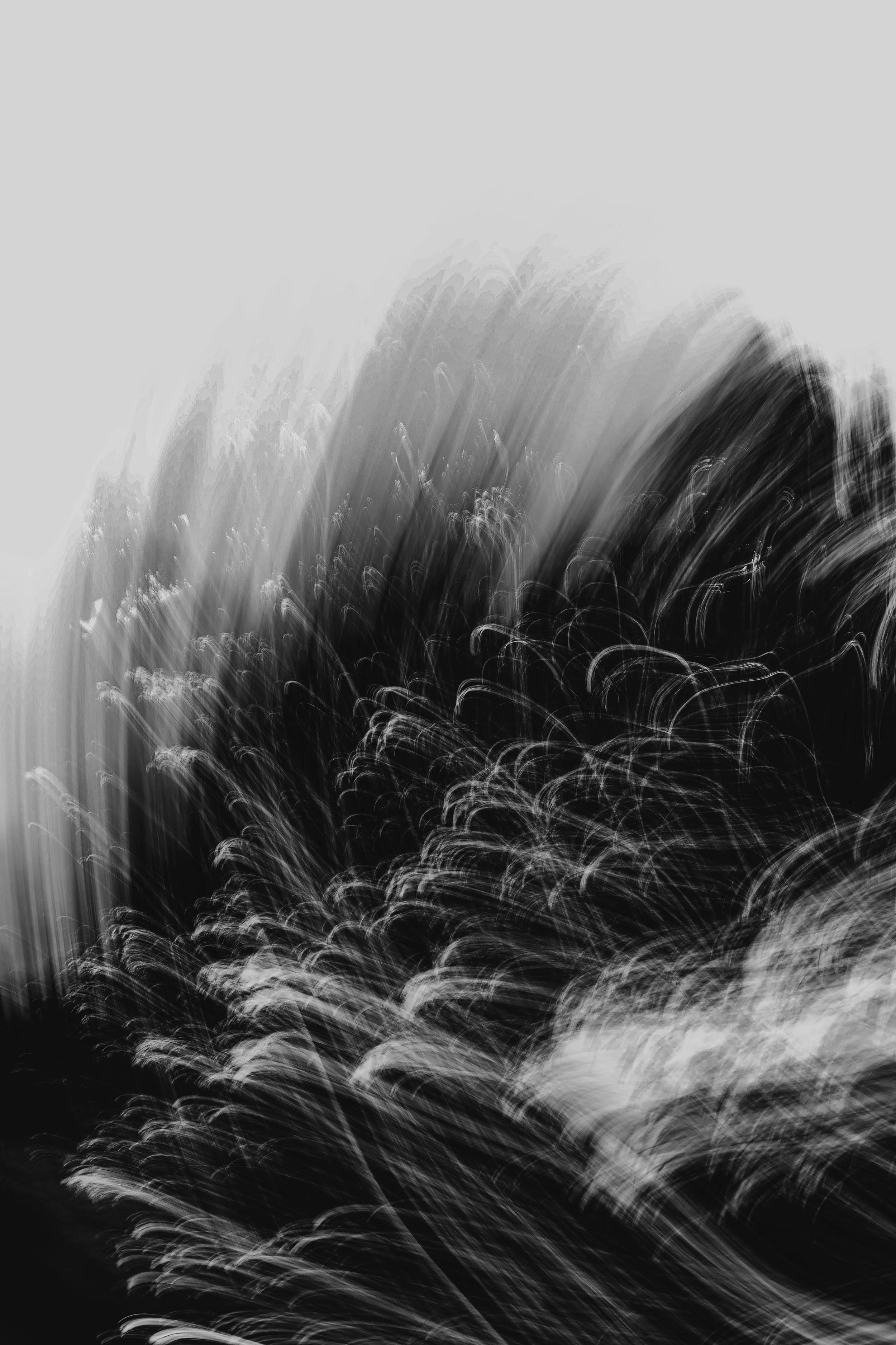 Abstract black and white photograph with blurred lines and swirling light patterns.