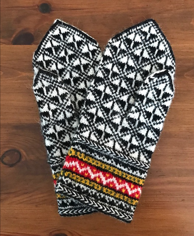 Black, white, and red Latvian mitten with geometric pattern