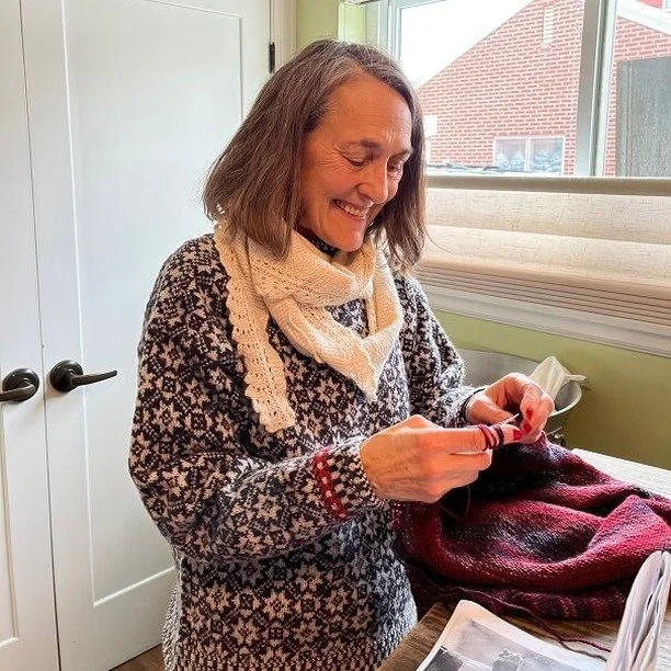 Lisa knitting and smiling