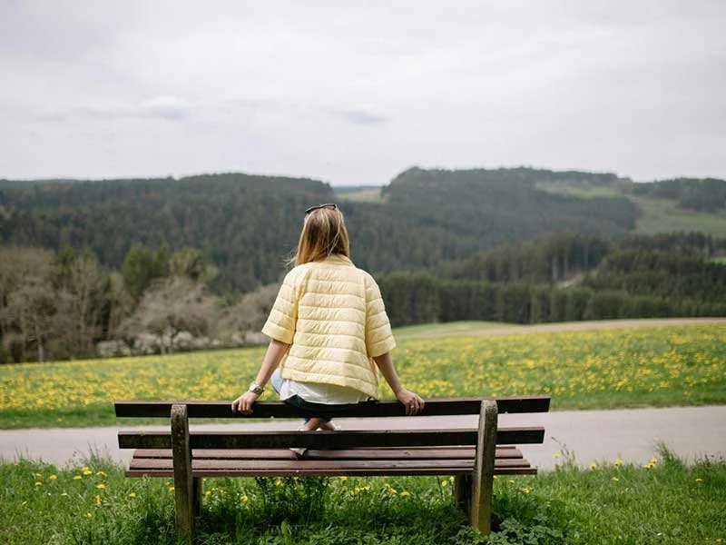 Woman sitting in nature after therapy session in Redding woman therapist
