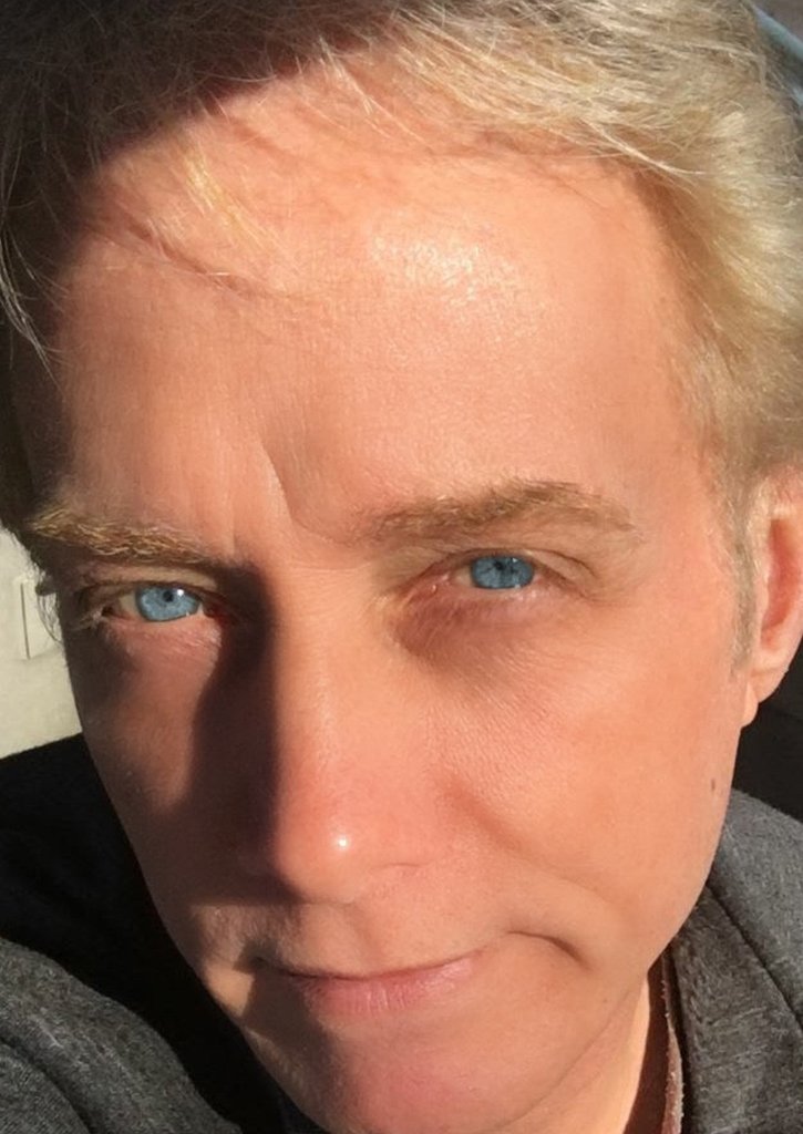 blue eyes grey jacket outside sun.jpg