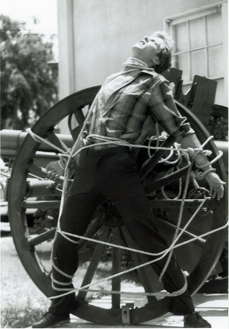 A young Michael Griffin tied tight to a cannon