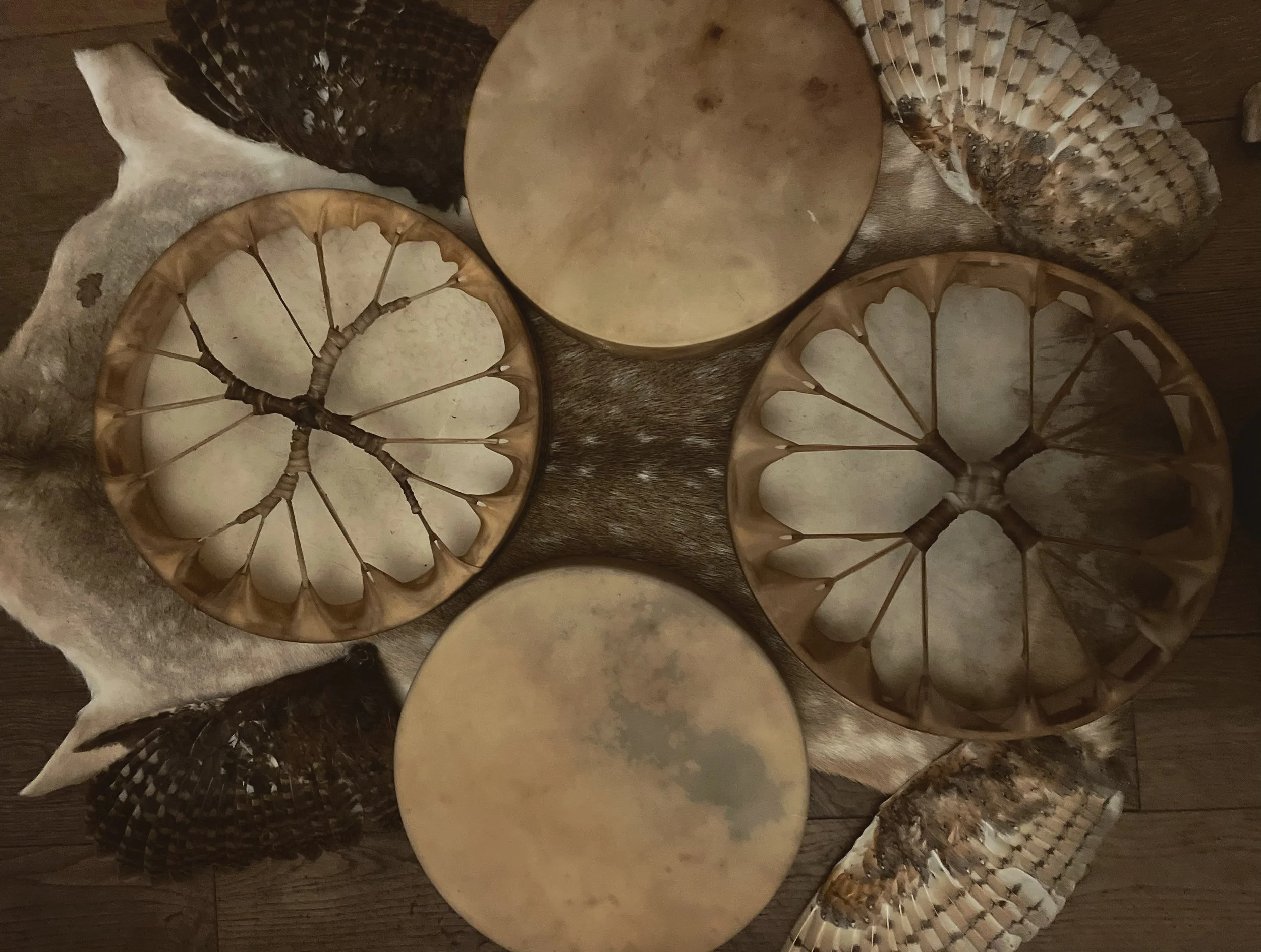 Four handmade drums on a deer skin