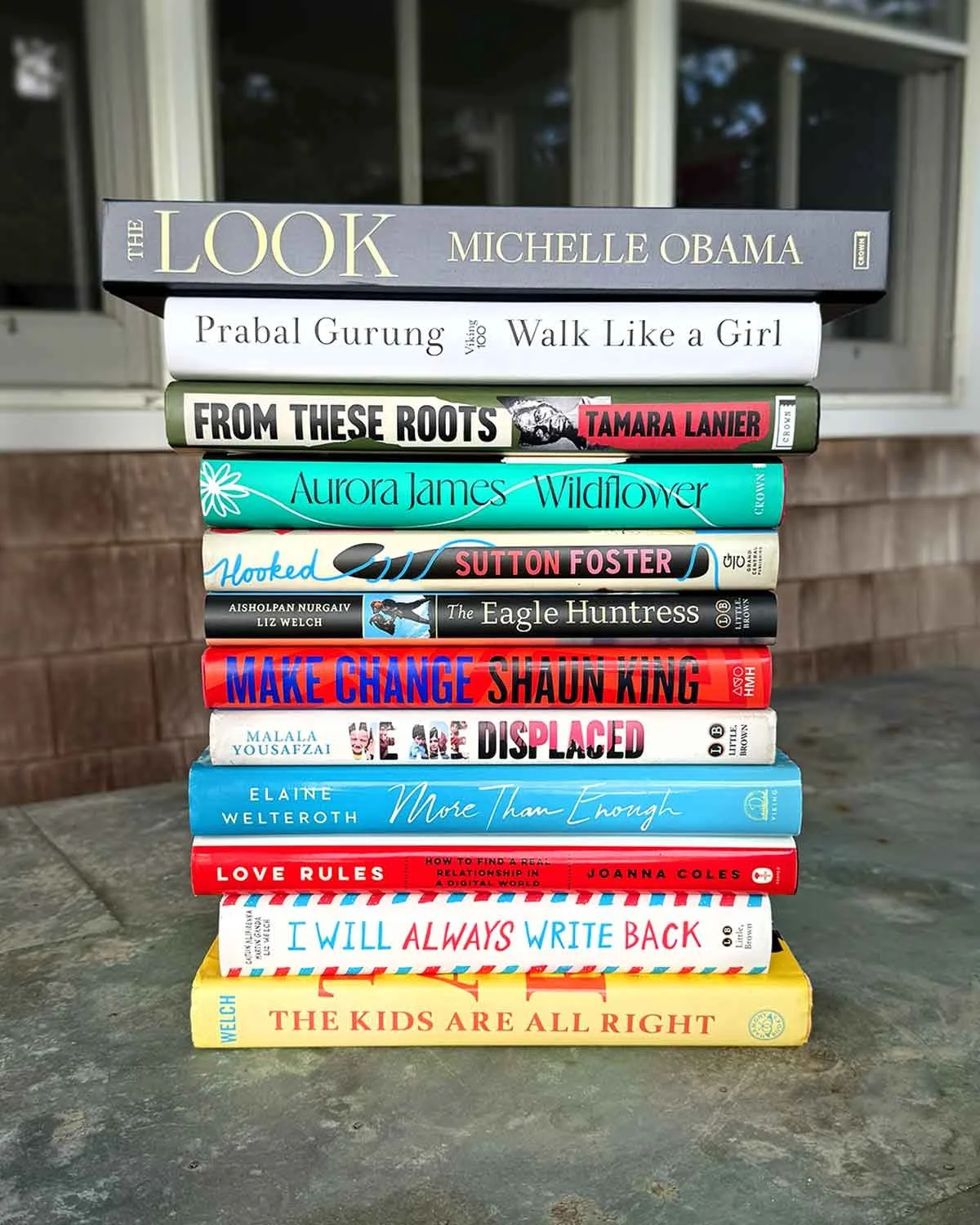 Liz Welch, author, stack of books on table
