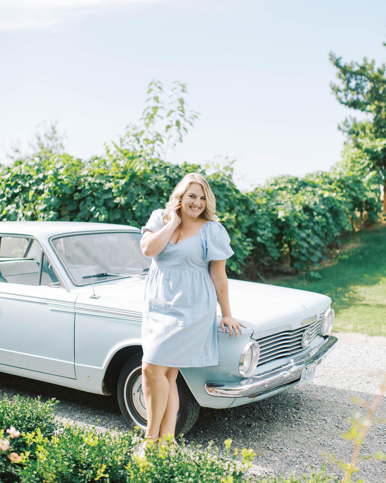 Kayla Knight Day By Knight Events Kelowna Wedding Planner Posing In Front of Mabel Mae Vintage Car Rental