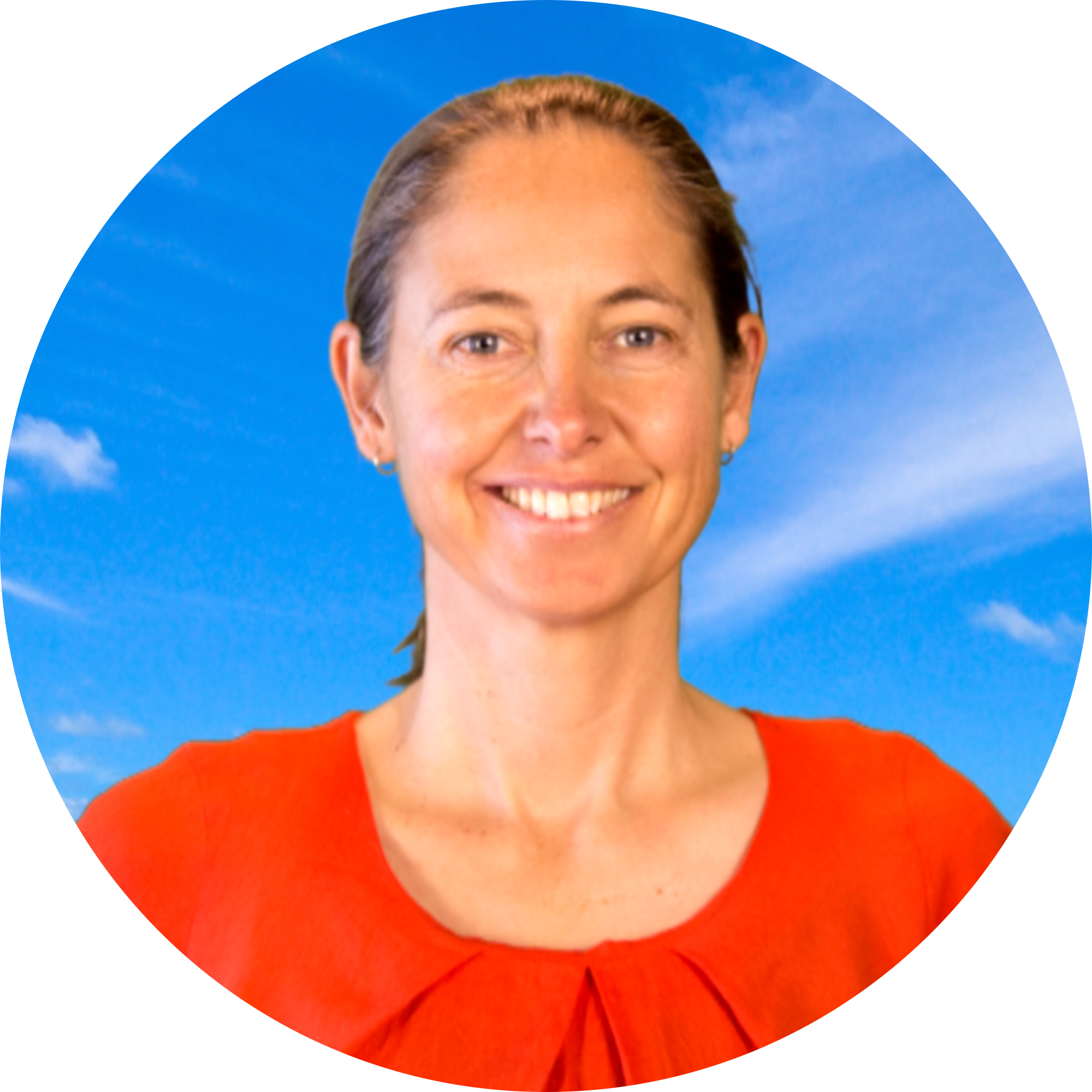 Woman smiling in front of blue sky background