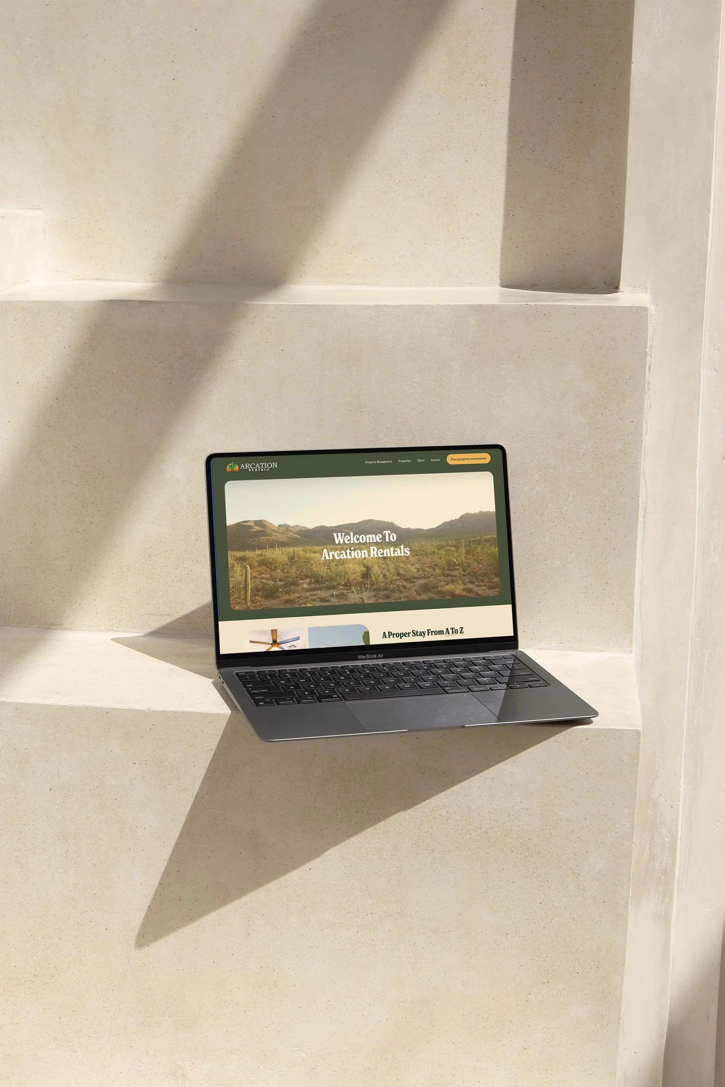 Website and mobile app interface for Arcation Rentals, featuring properties in desert landscape with mountains in background, and interior images of rental homes.