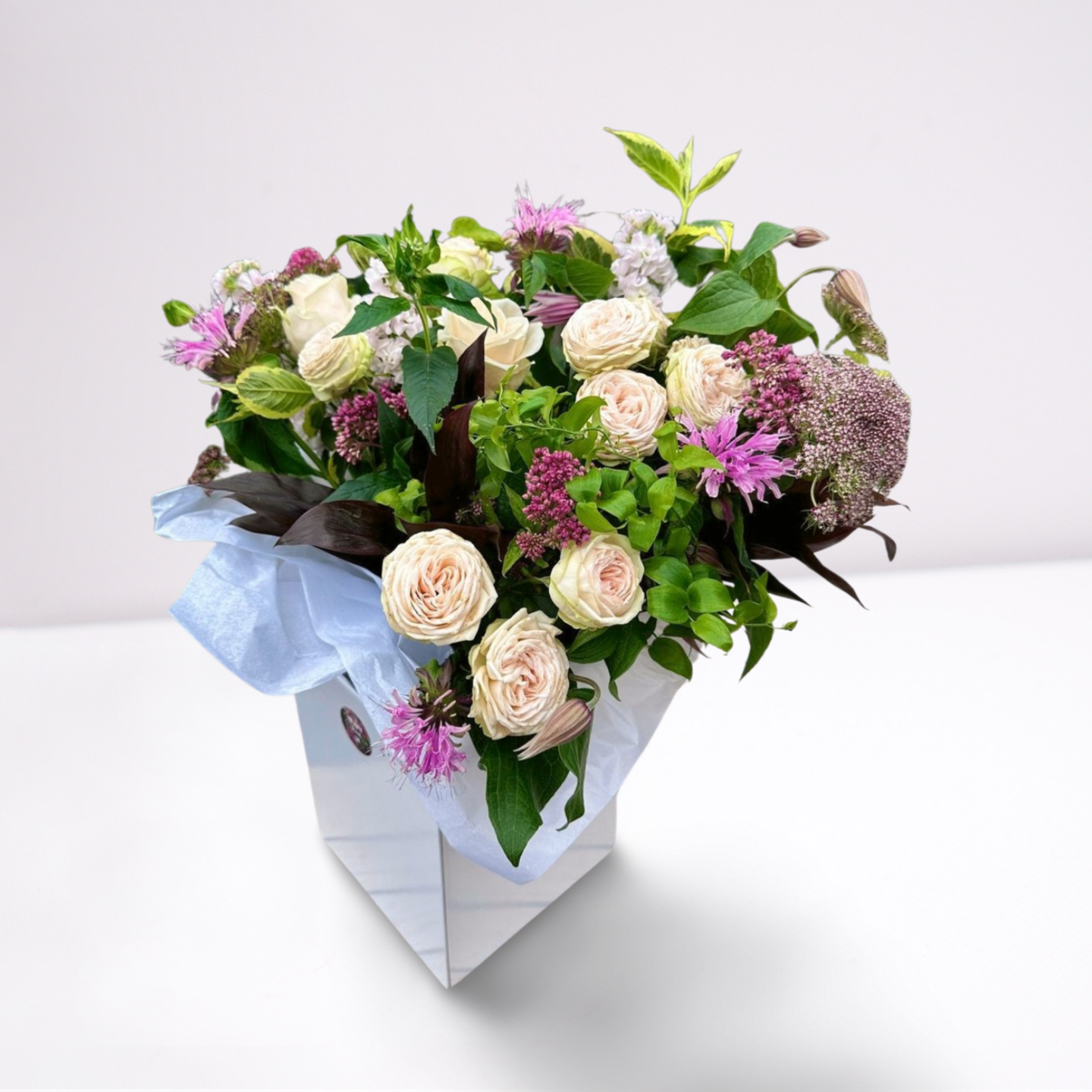 The Westminster College bouquet full of purple, white, pink flowers presented in a luxury box The Westminster bouquet by Flowerverse of Cambridge
