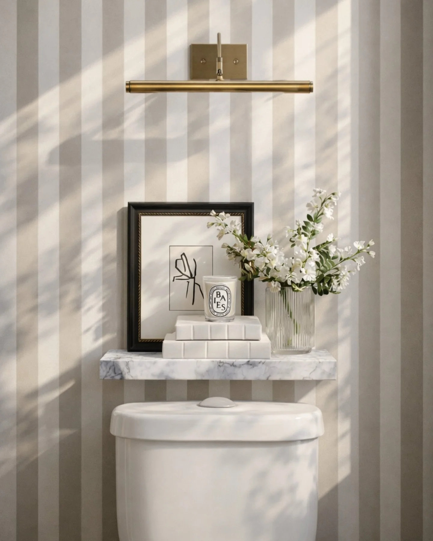 If your powder room feels like an afterthought&hellip; this is how you fix it 👇

Small space, but every detail is working harder:
&bull; Vertical stripe wallpaper = instant height + polish
&bull; A picture light turns anything into a focal moment (e