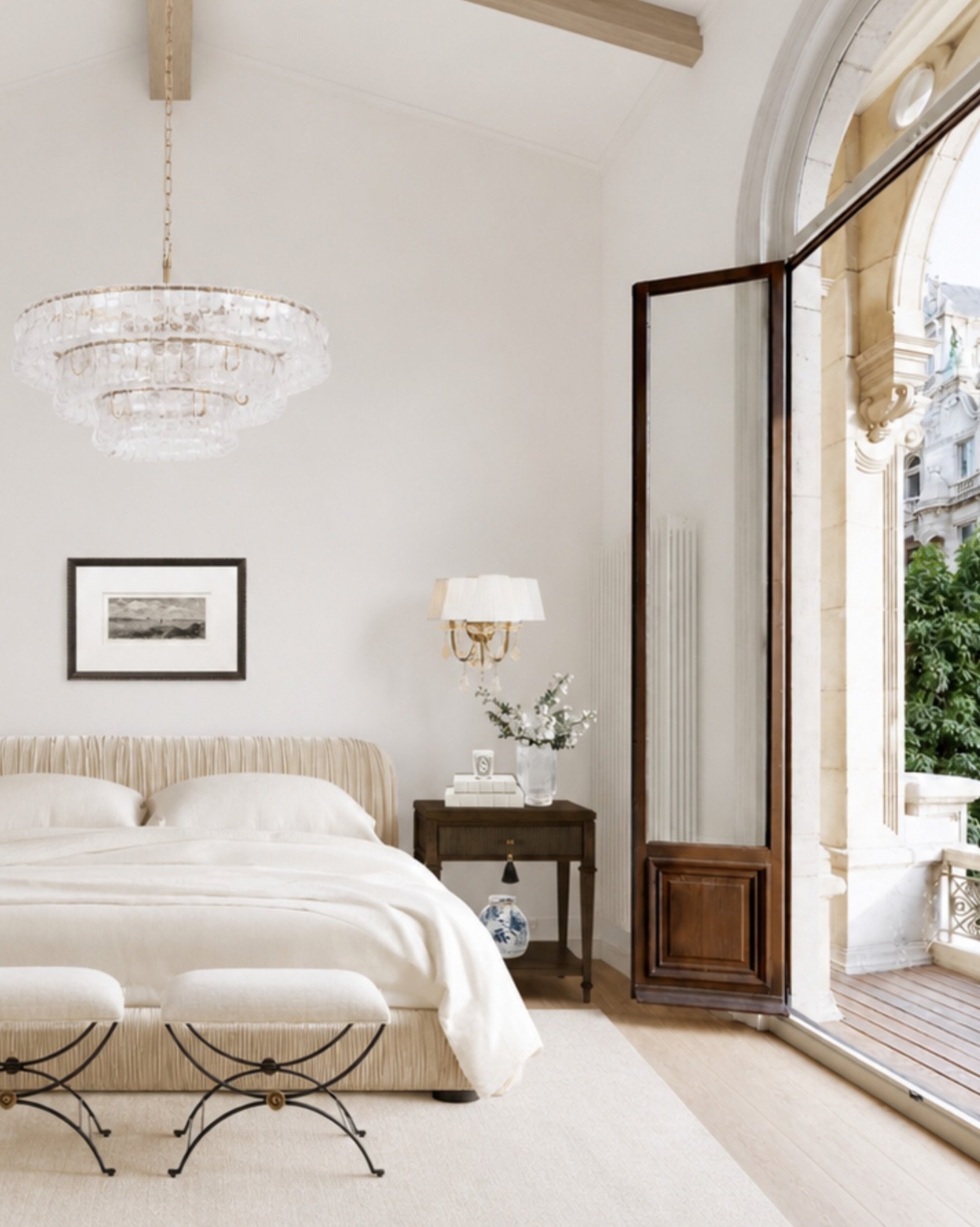 The kind of bedroom that makes staying in feel better than going out 🤍

Soft layers, a skirted bed, little upholstered benches, warm wood, and a statement chandelier make this feel elegant without being too precious. I love how the whole space feels