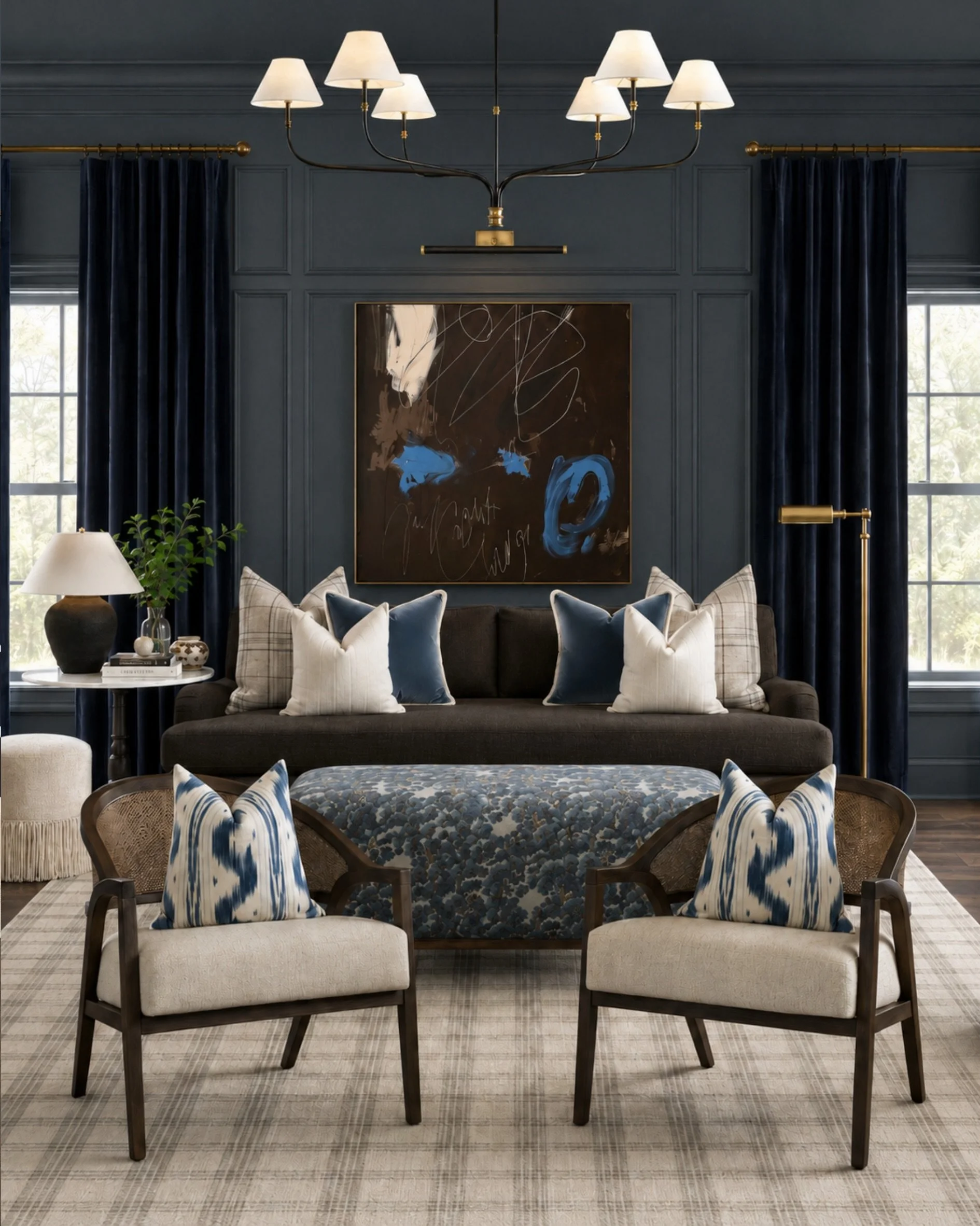 Moody blue done right. This living room has the drama of dark walls and rich drapery, but the cream upholstery, warm brass, layered pillows, and natural wood tones keep it feeling inviting instead of heavy.

A polished, collected look for anyone who 