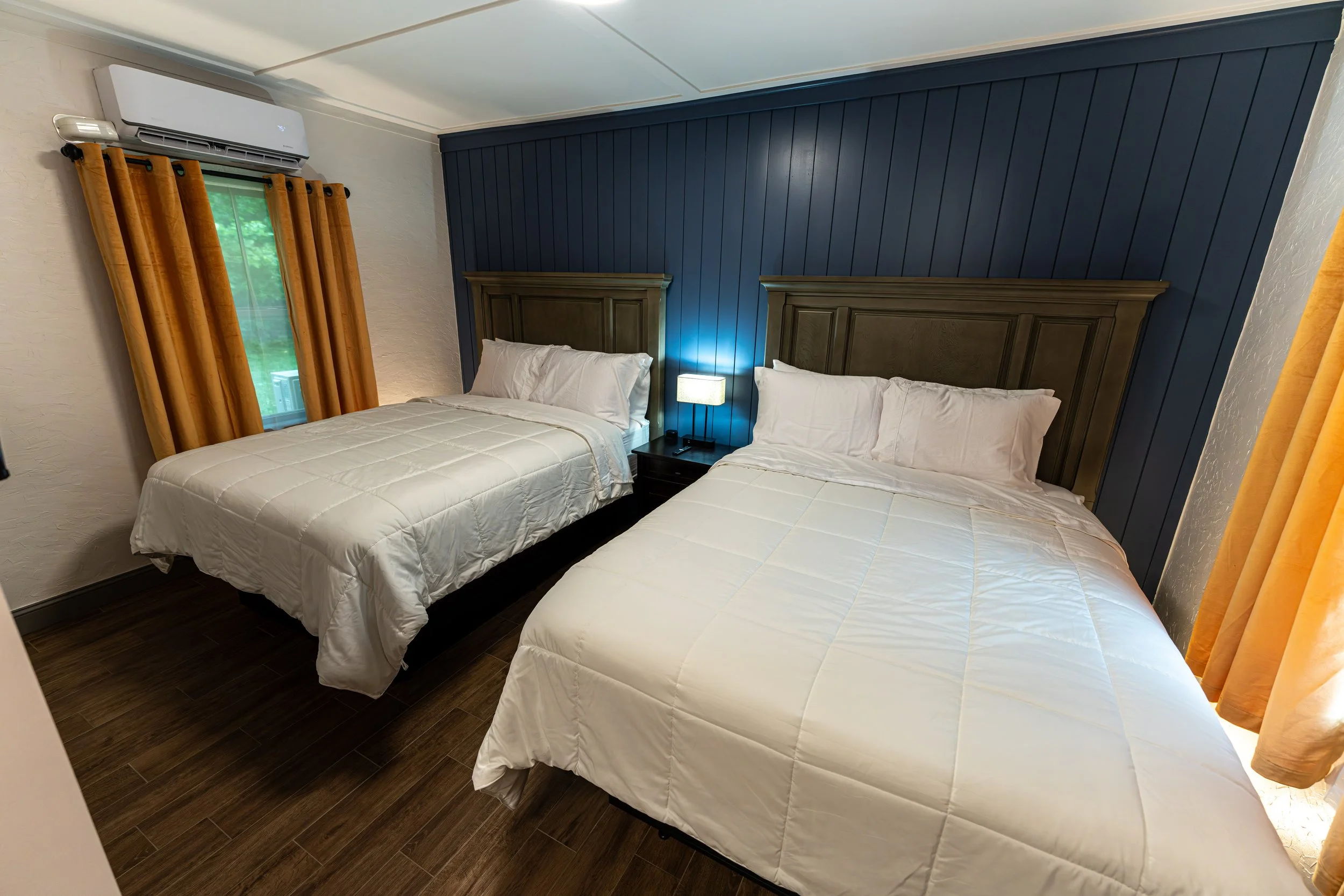 Room 4 double-queen bedroom at Shamrock Court, a restored historic Route 66 motel in Sullivan, Missouri.