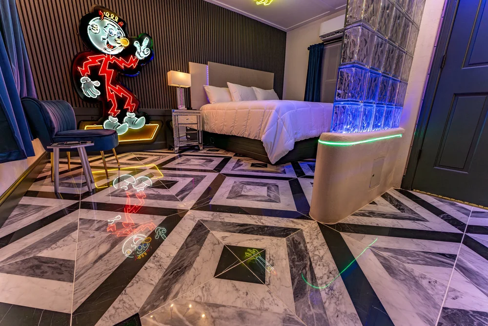 King bed and marble-pattern flooring in the Neon Room.