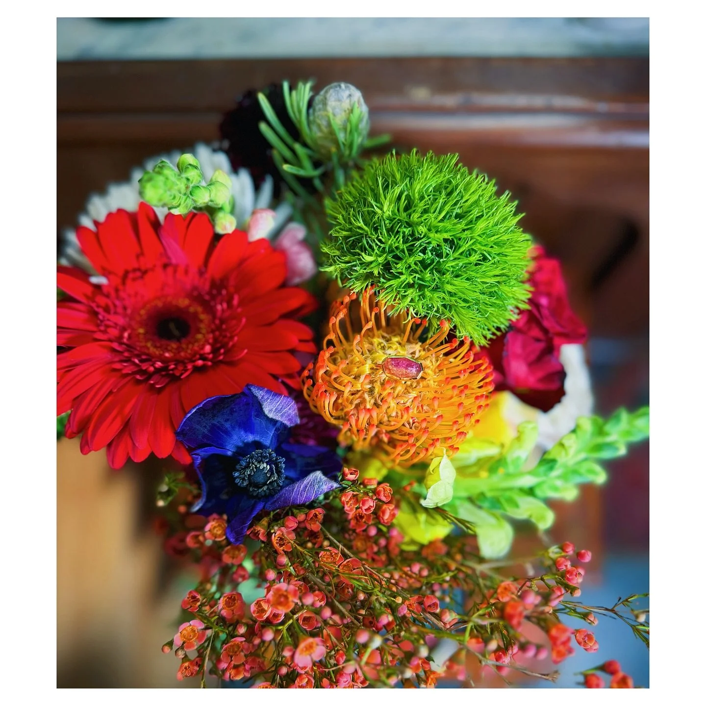 When fall is in the air, I like to play with flowers and jewelry 
Can you name the flower my ring is resting in?