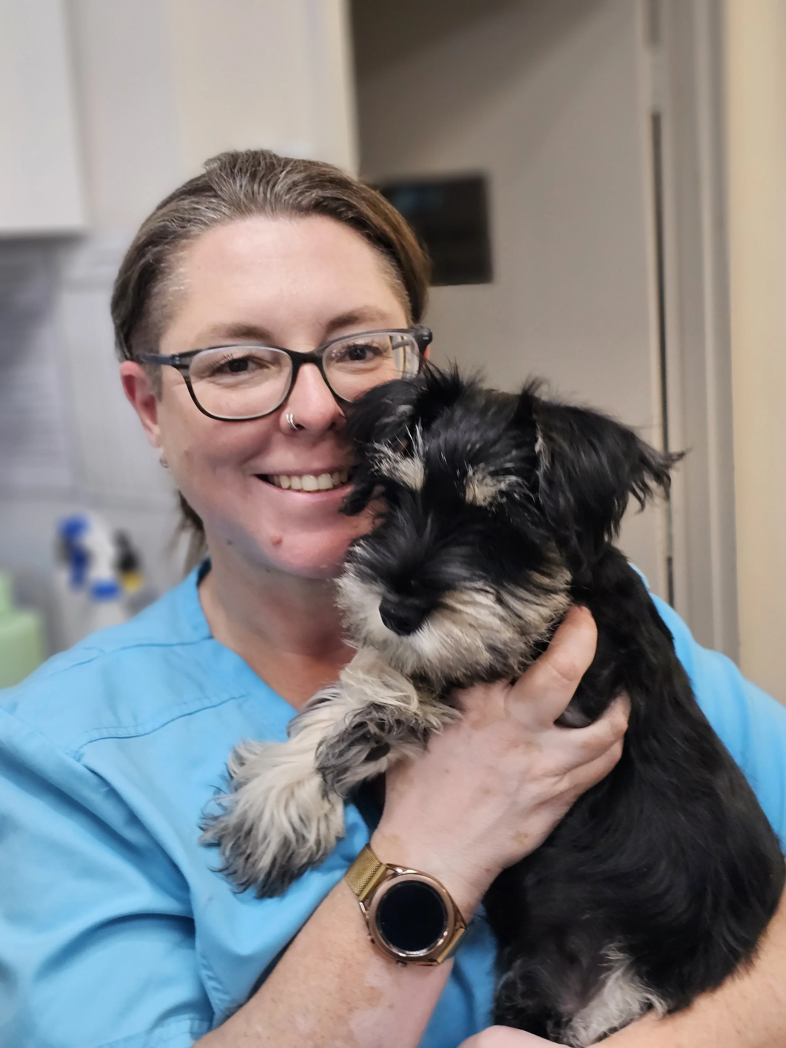 Liz the puppy school trainer with a Schnauzer puppy in her arms