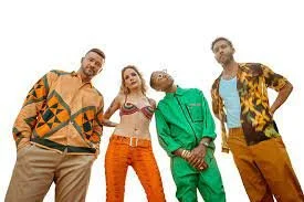 Four young adults standing together, wearing colorful casual outfits, against a white background.