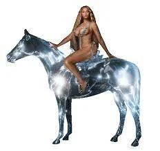 A woman is sitting on a shiny, illuminated horse-shaped sculpture.