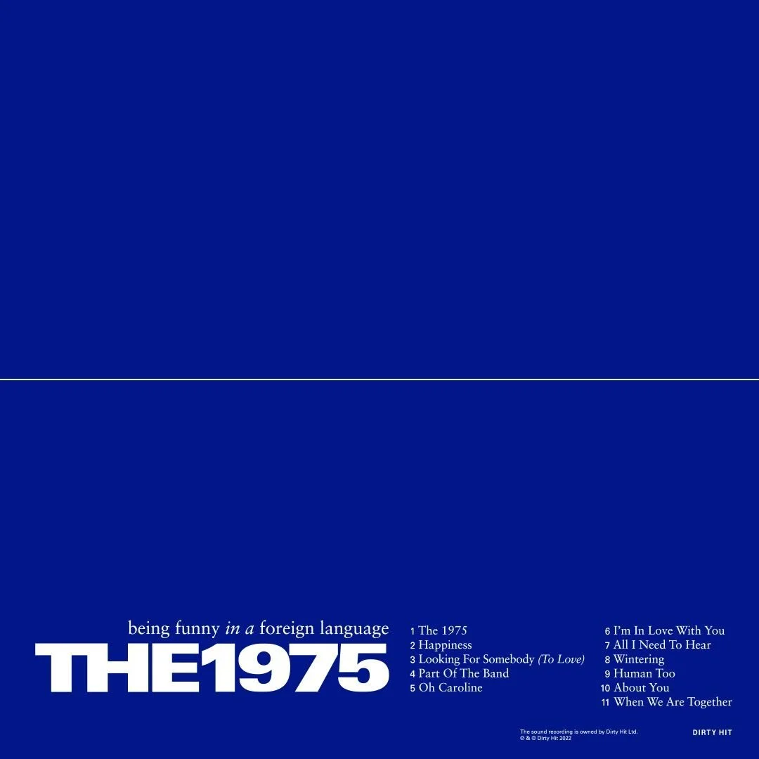 Album cover for 'The 1975' with a blue background, white bold text, track list, and record label information.