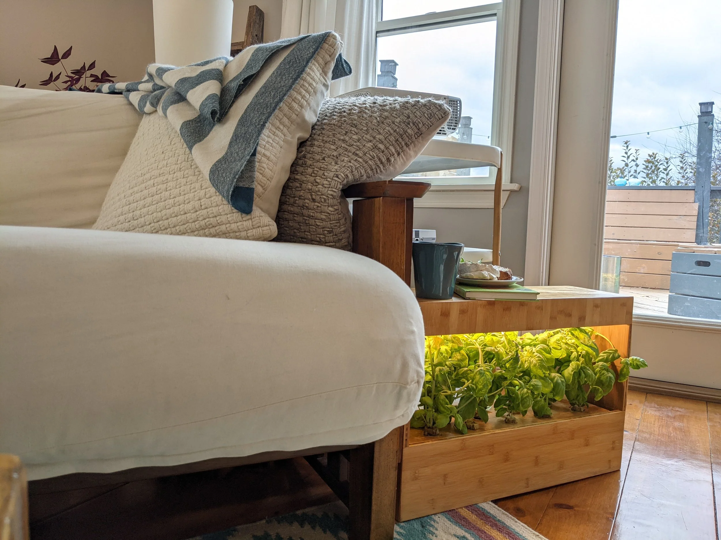Photo of a Plant Box placed next to a couch where Plant Box is serving as a side table.