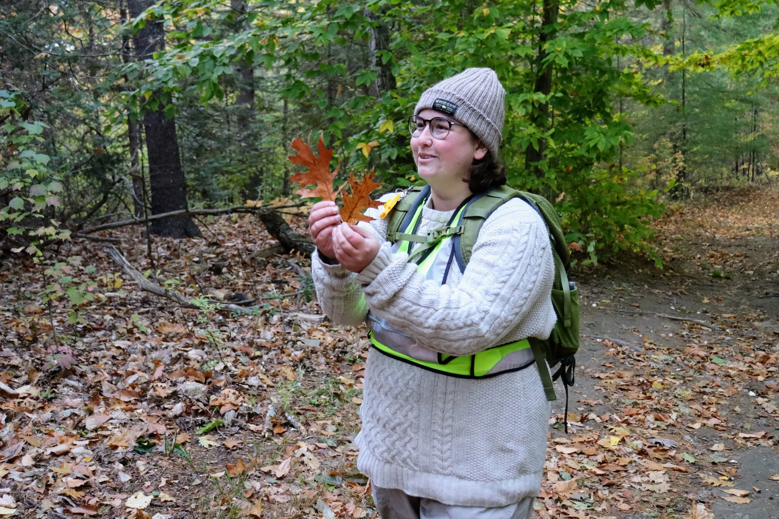 Davinica holding up two leaves while teaching