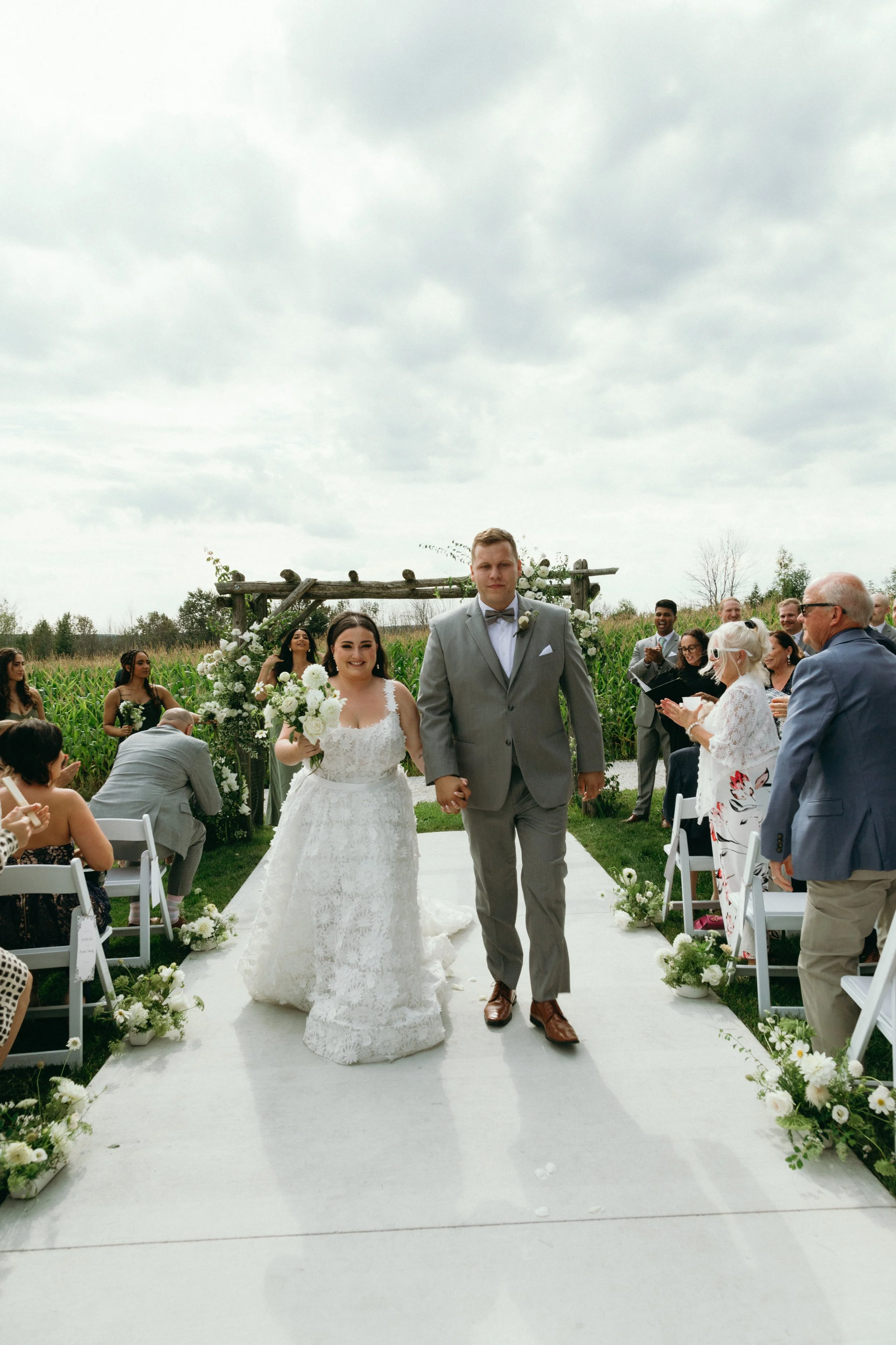 Elegant white and green floral centerpiece with blush peonies and soft greenery, created by a wedding florist in Pickering.