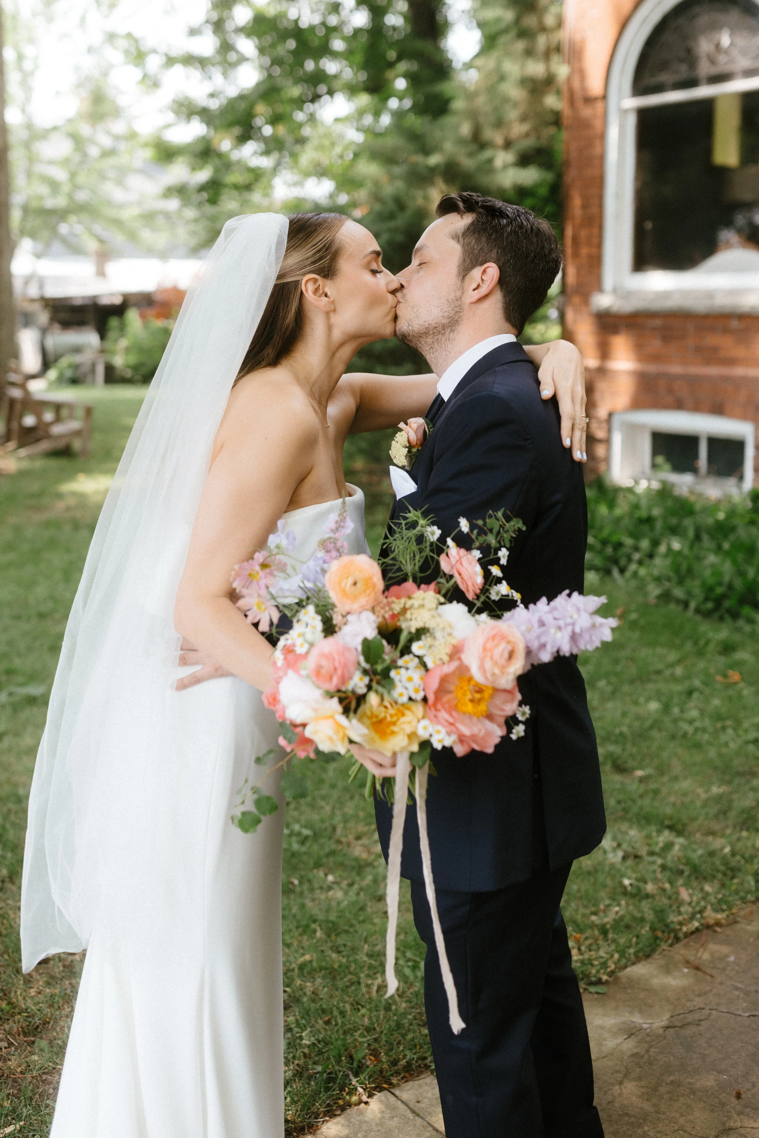 Spring wedding with bridal bouquet with peonies and fresh grown flowers from florist in Pickering