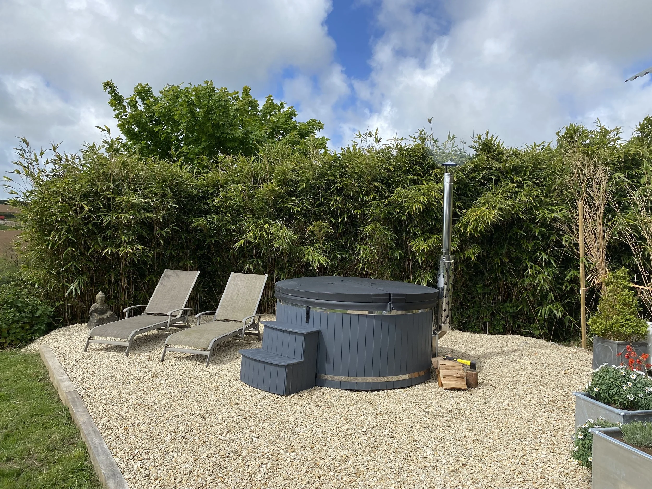 Amber wood fired hot tub at Holiday in a hand built quality shepherd hut located at Moonshadow Luxury Shepherd Huts in Cornwall