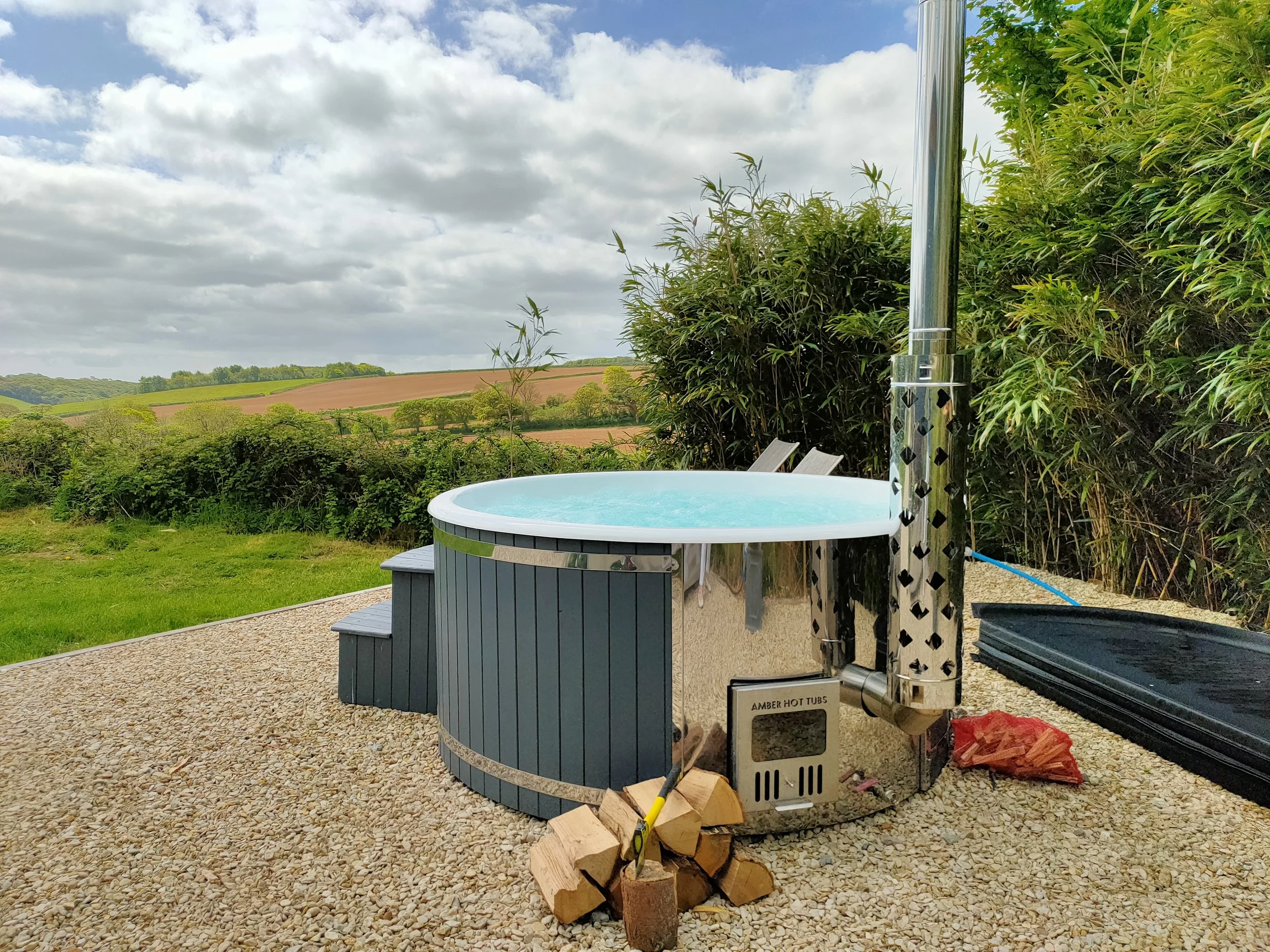 Amber wood fired hot tub at Stargazey at Moonshadow Luxury Shepherd Huts in Cornwall
