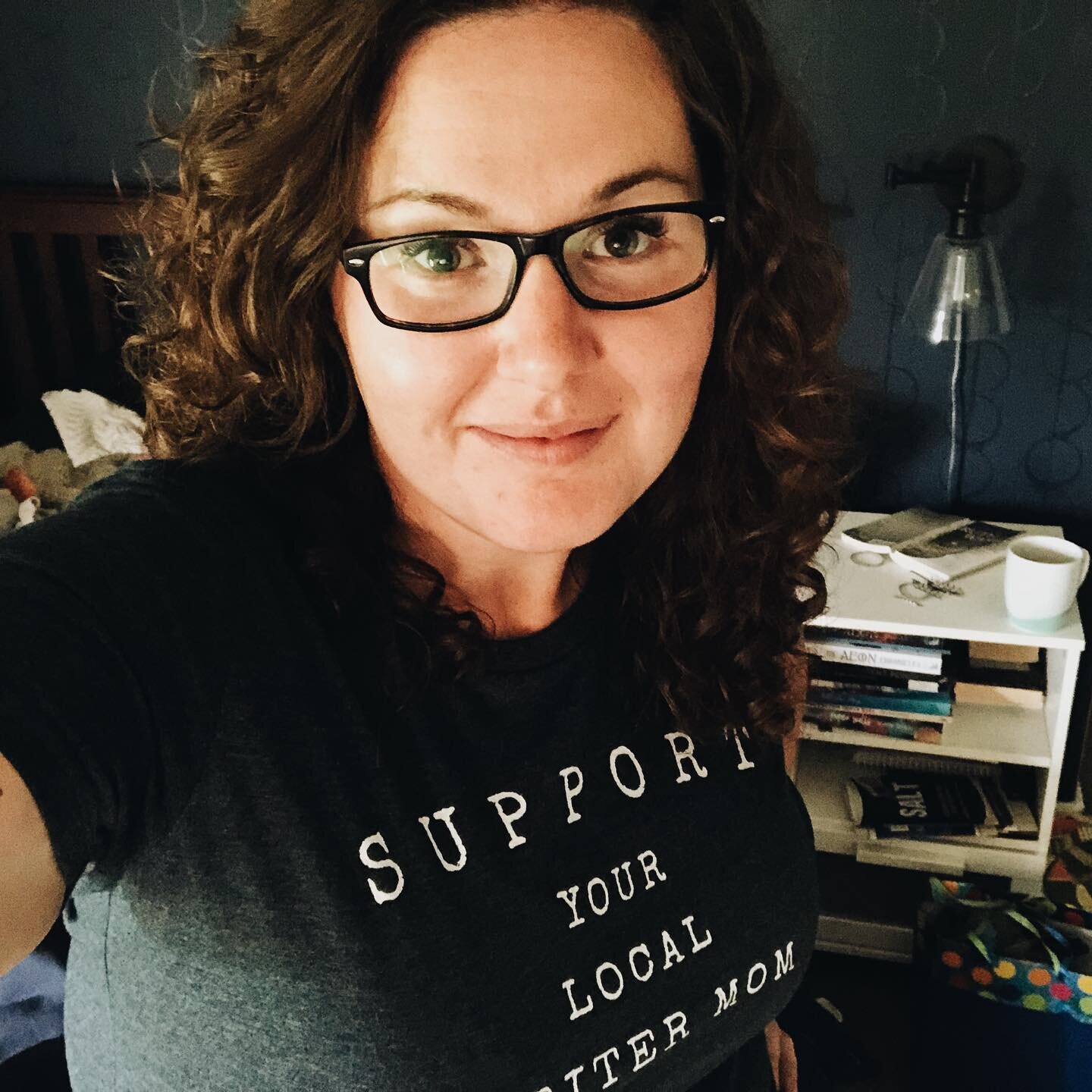 Look what came in the mail today!! I&rsquo;m loving my new #writermomsinc shirt ❤️
.
Pictured: laundry to be folded, cold coffee, a gigantic tbr pile, a mama in desperate need of a nap 
Not pictured: anything writing related, extra time in the day
He