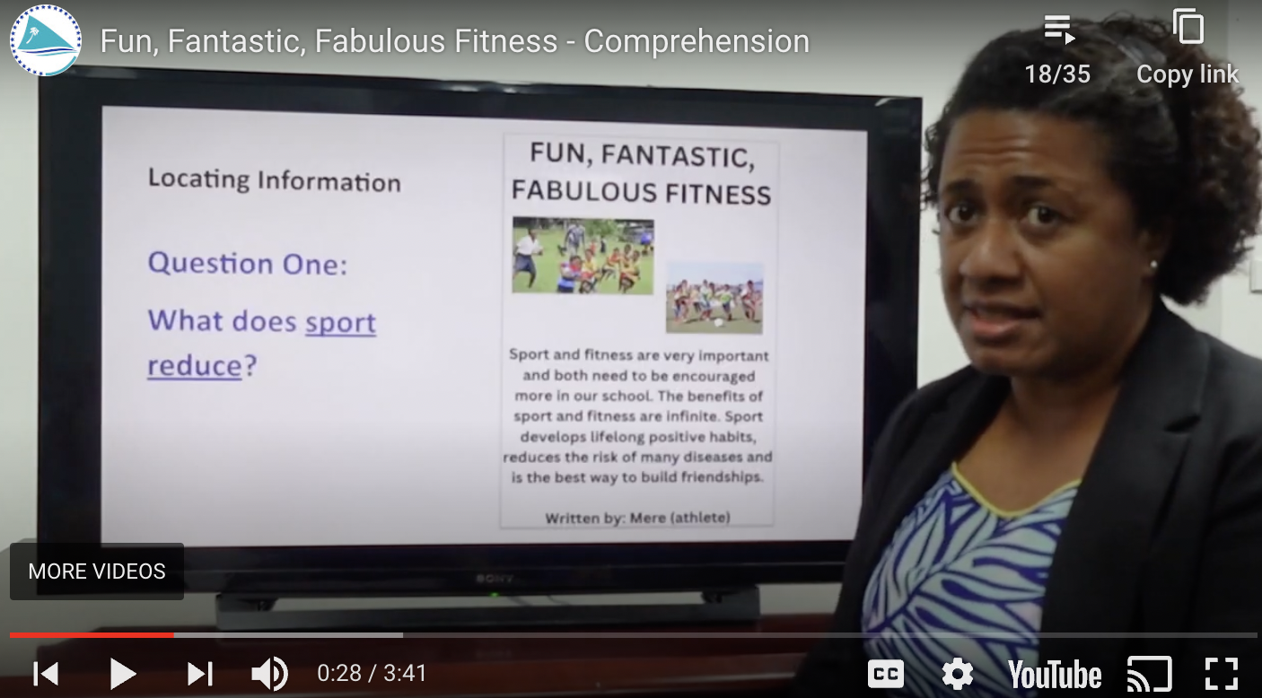 A woman standing next to a screen displaying a presentation titled 'Fun, Fantastic, Fabulous Fitness.' The screen shows a comprehension question, 'What does sport reduce?' and text about the importance of sport and fitness. The bottom of the screen shows typical YouTube interface elements such as play button, volume, and video duration.