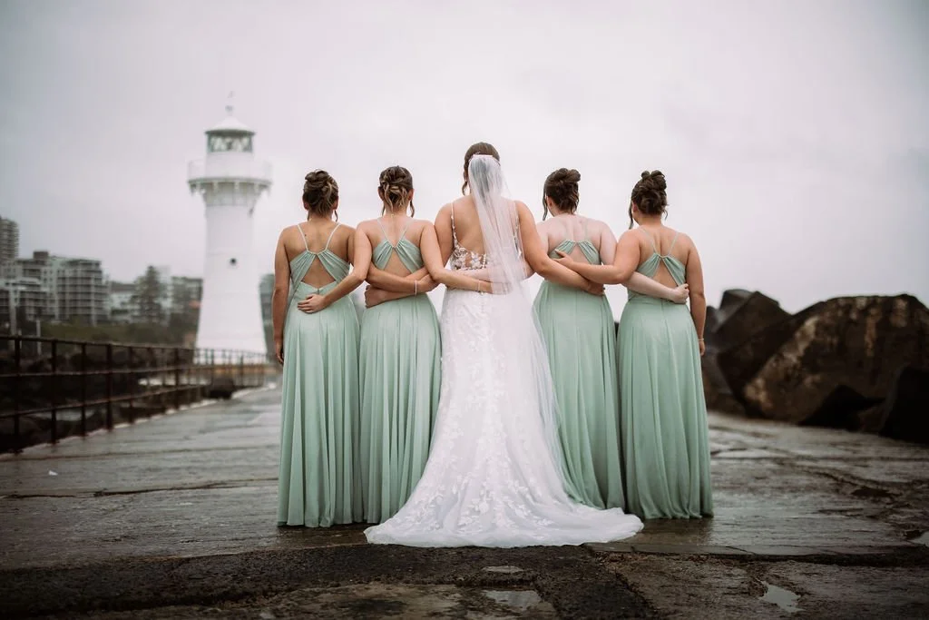 Maddison with her bridesmaids photographed from behind in matching mint green dresses