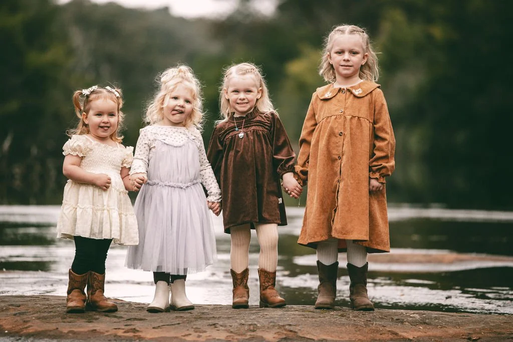 Four young wedding guests standing together during Bronti and Juan-Ruan’s outdoor wedding