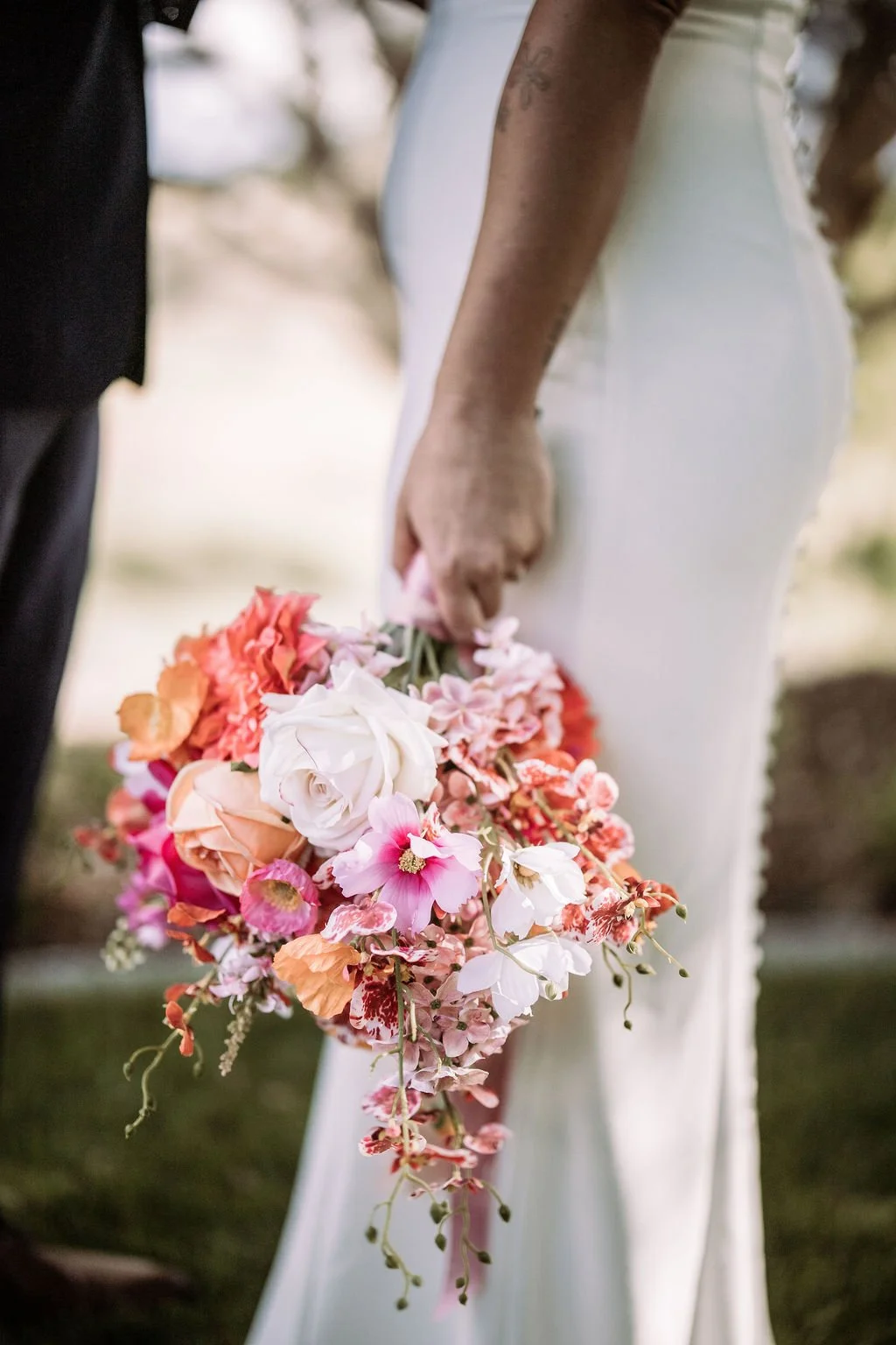 Close-up of Bec holding a colourful wedding bouquet
