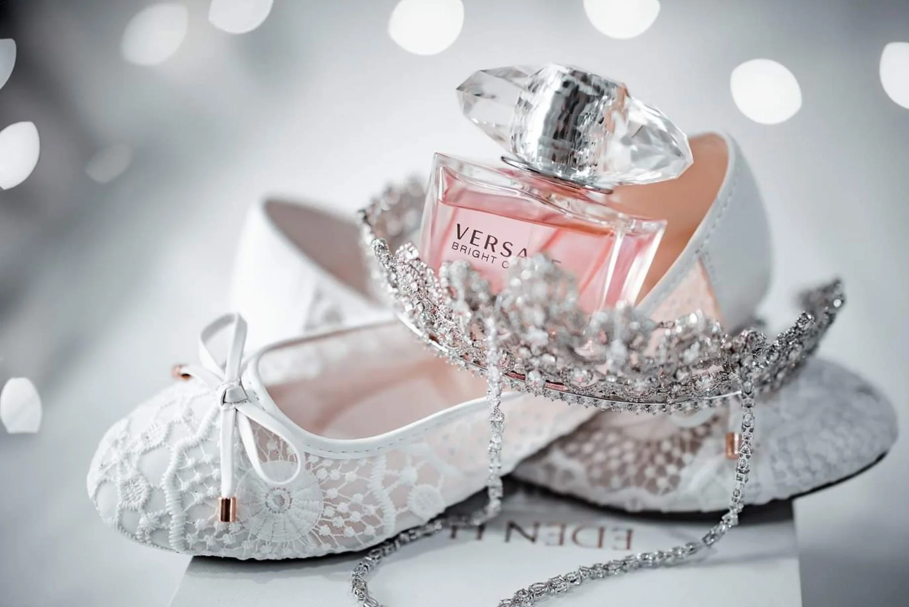 Bridal shoes, perfume and jewellery photographed before the wedding