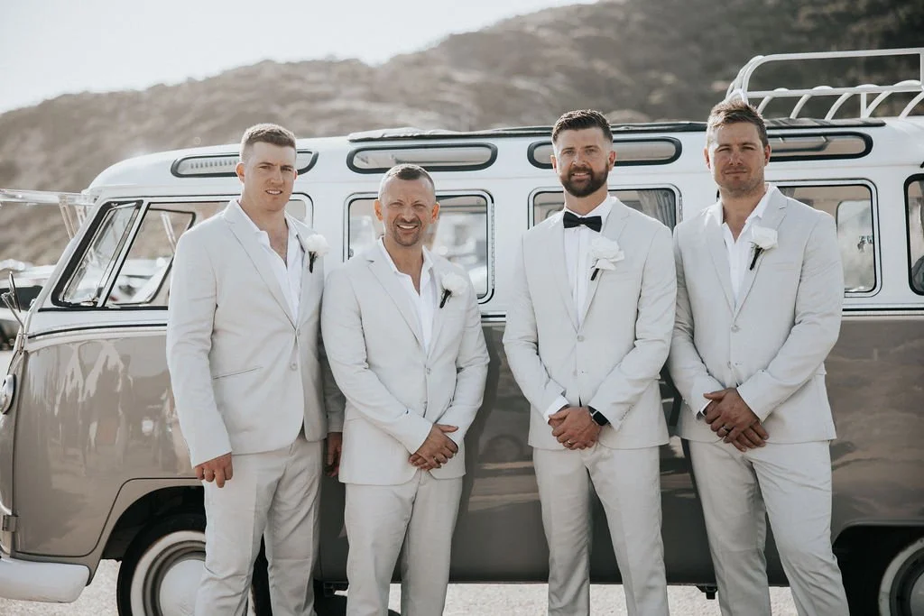 Blake with his groomsmen posing beside the vintage Kombi on the wedding day