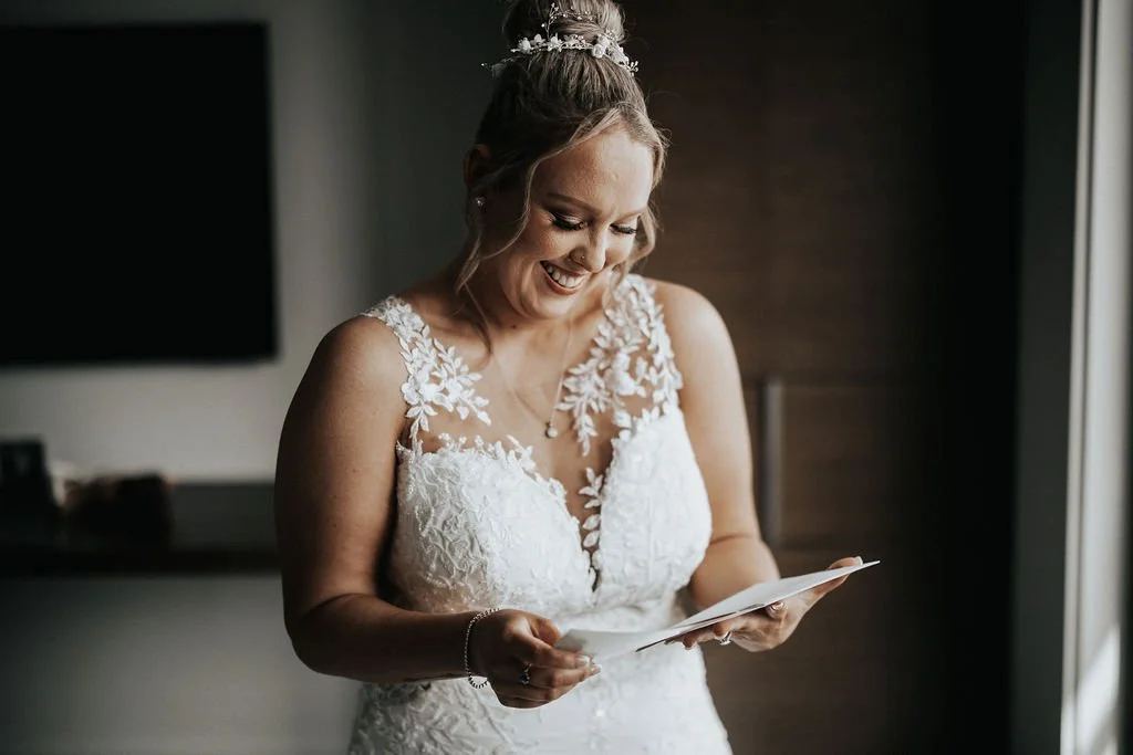 Bride reading a handwritten letter during Carla and Amie’s wedding preparations