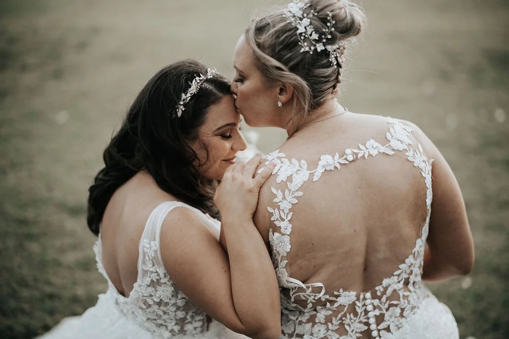 Carla and Amie embracing during their wedding portraits