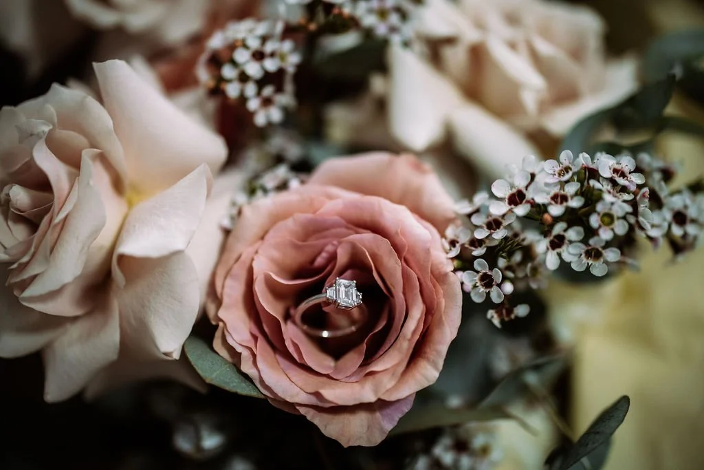 Maddison’s wedding ring displayed inside a pink rose bouquet