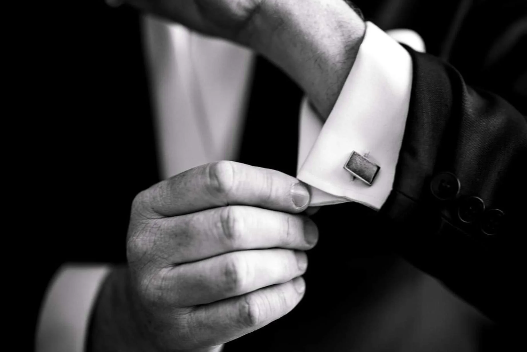 Groom adjusting his cufflink before the wedding ceremony