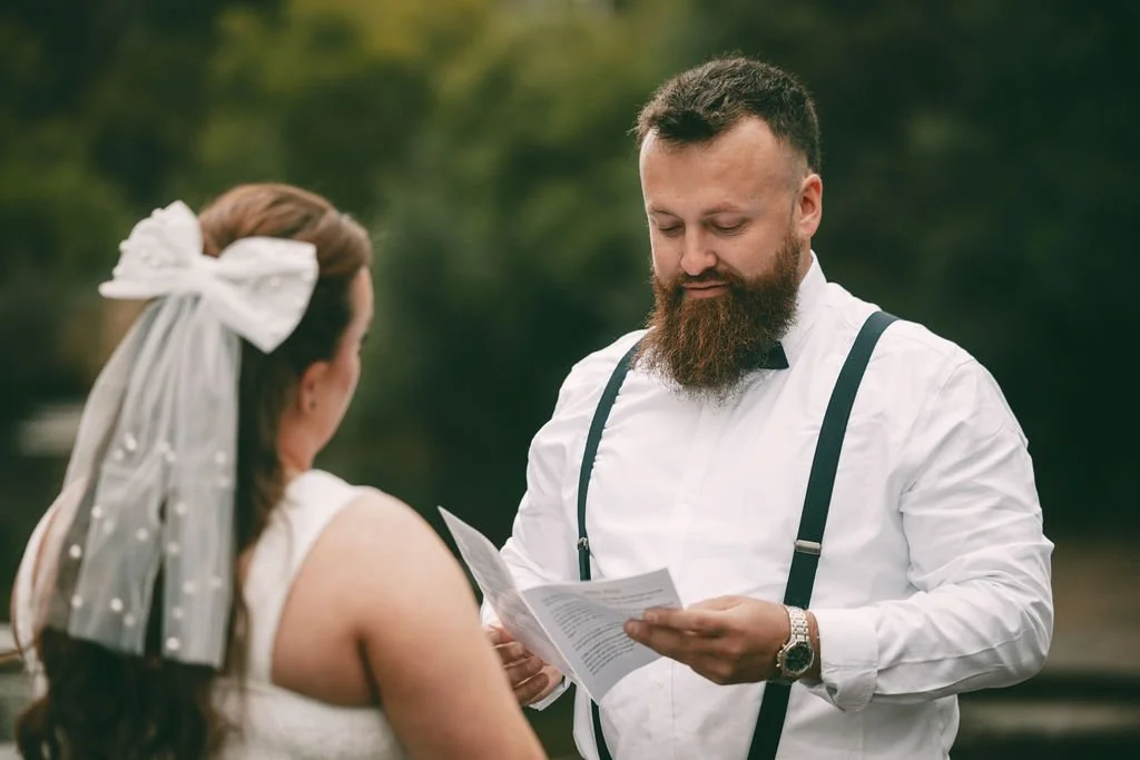 Juan-Ruan reading his vows to Bronti during their outdoor wedding ceremony