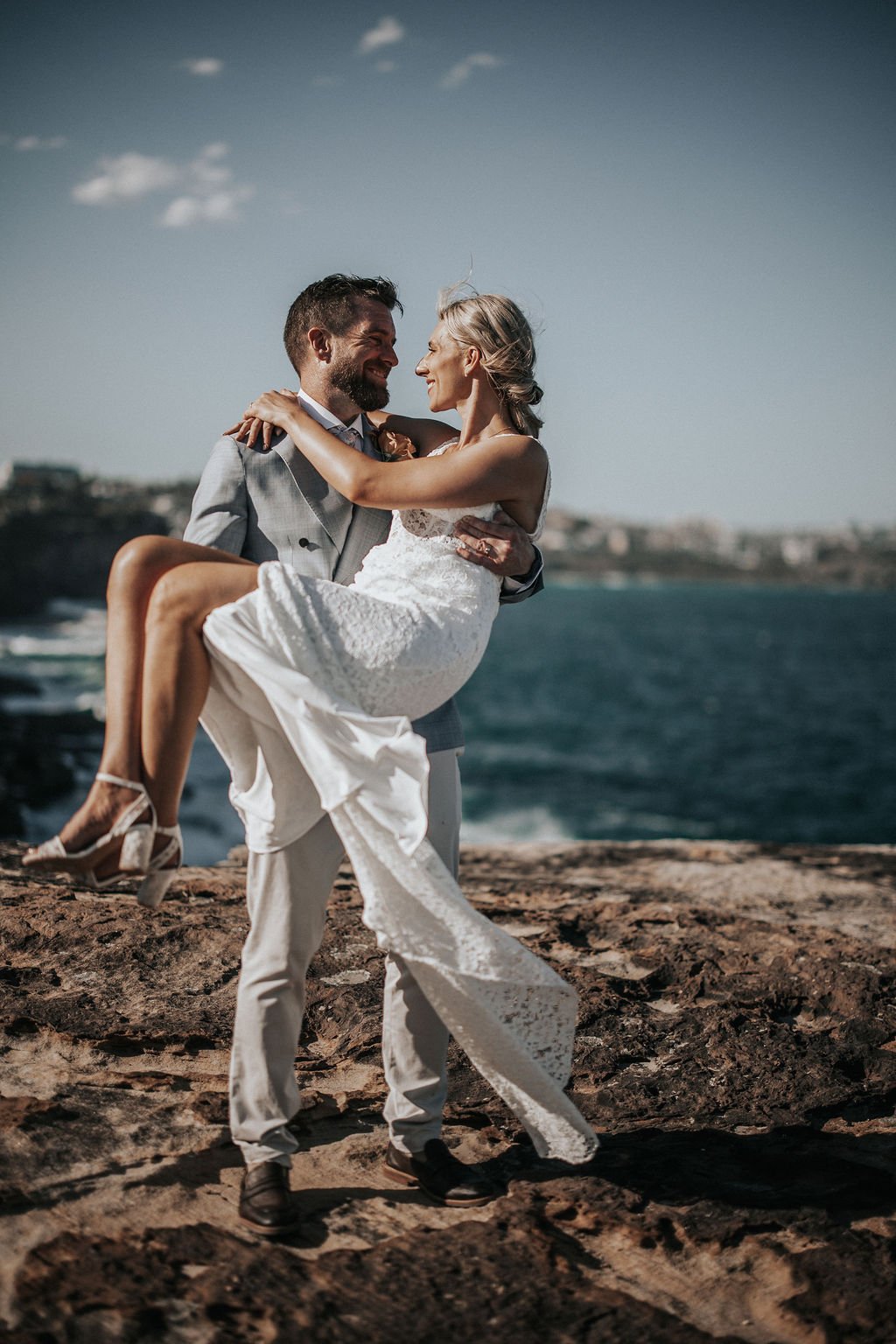 Chris carrying Erica during their coastal wedding portraits