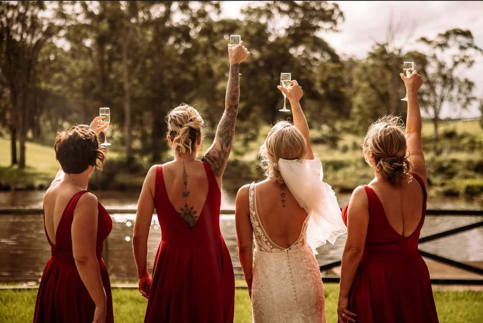 Bride and bridesmaids celebrating together outdoors