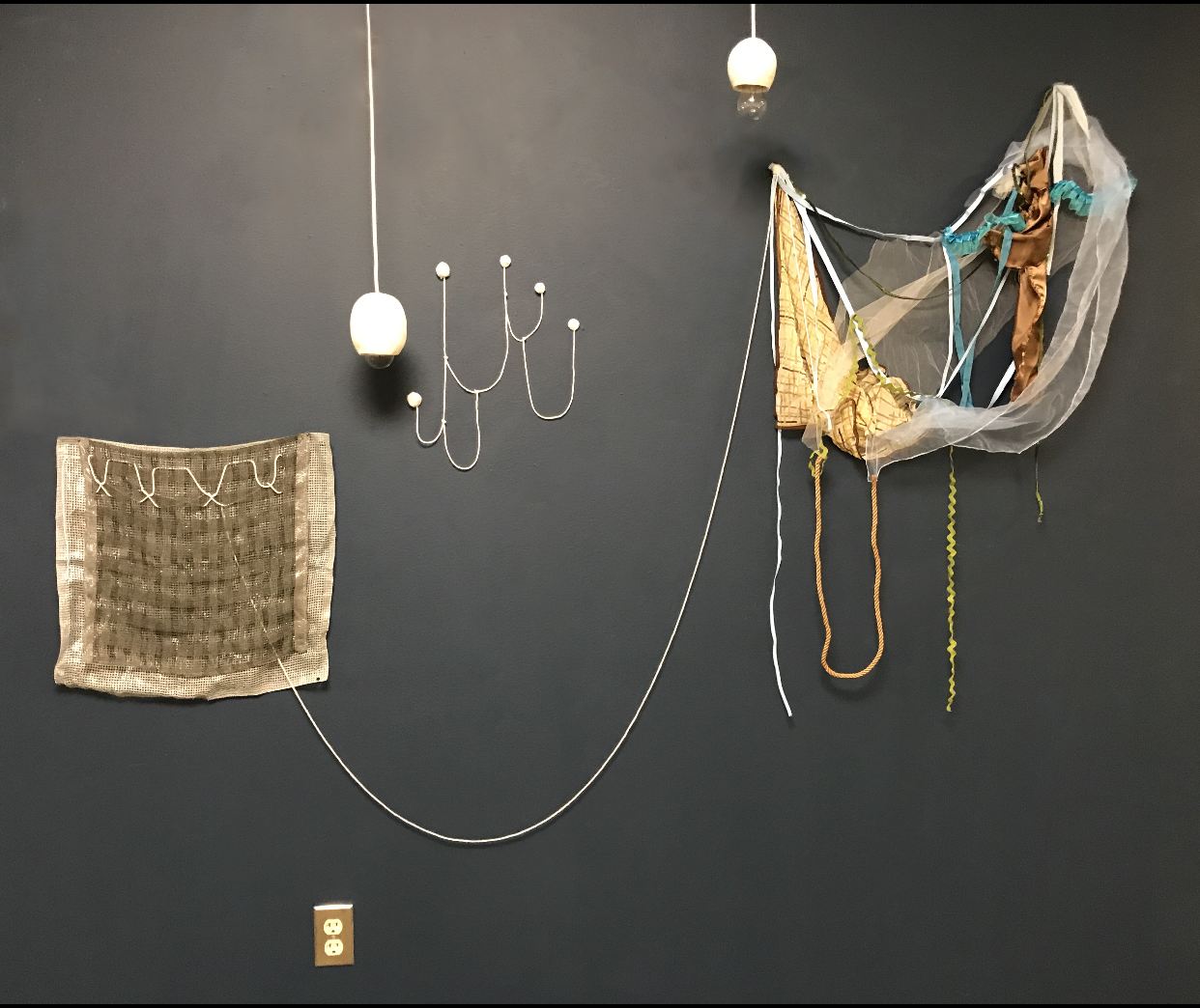 Anne Trauben_Gorey_s Visit_2020_remnant fabric, remnant trim, string, pom-poms, porcelain, electrical cord, electrical socket, lightbulb, scarves, map pins_7 ft tall x 6 ft wide (dim variable).PNG