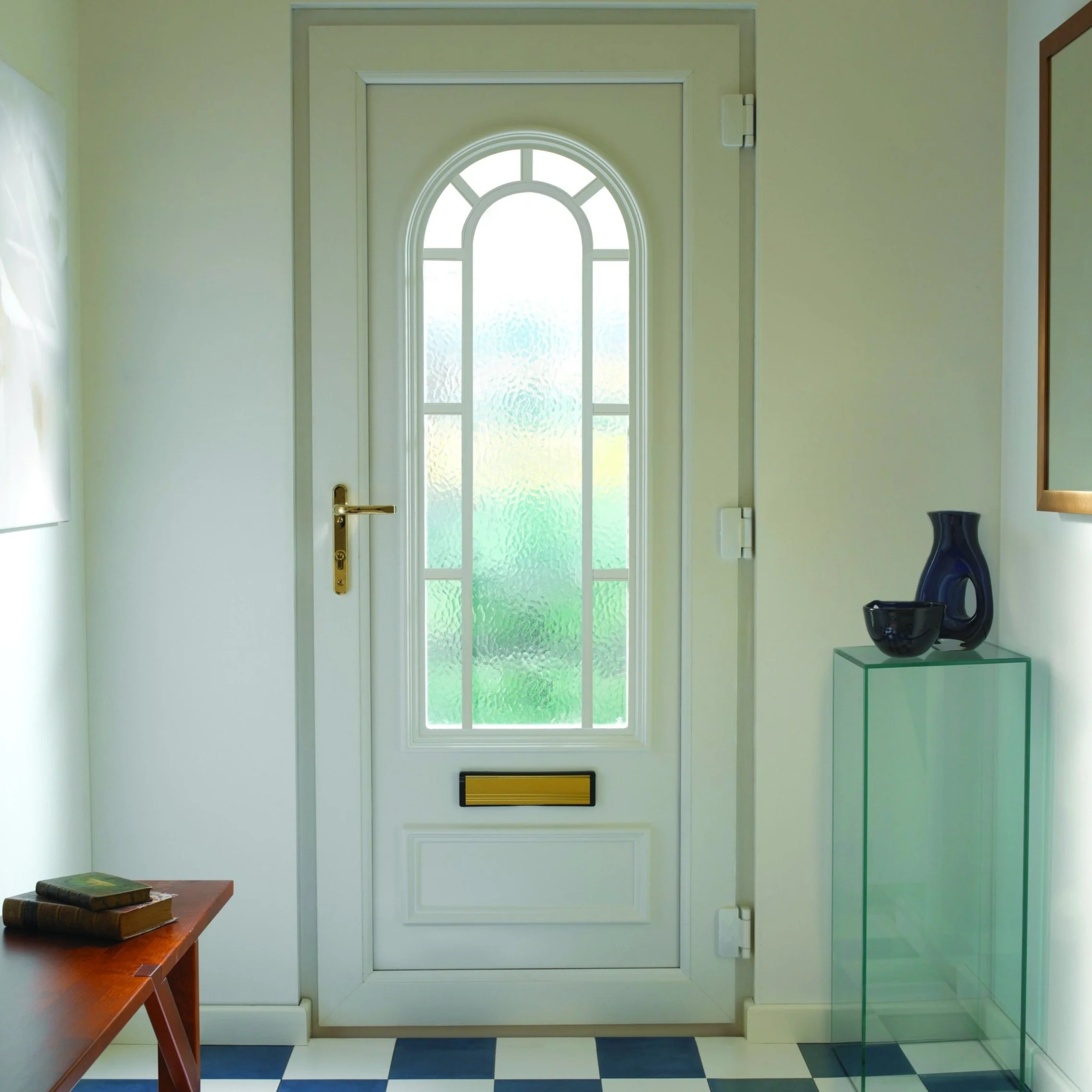 White UPVC panel front entrance door with arched Georgian decorative glazing with gold door furniture door handle and letter plate