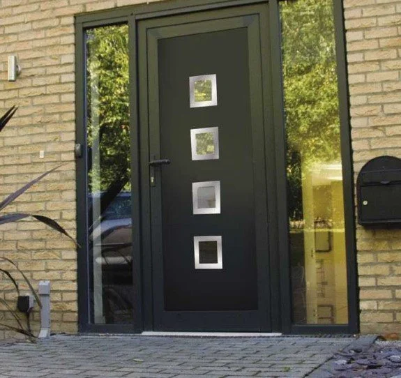 Black front door with four square glass panels, flanked by glass side panels, in a brick house.