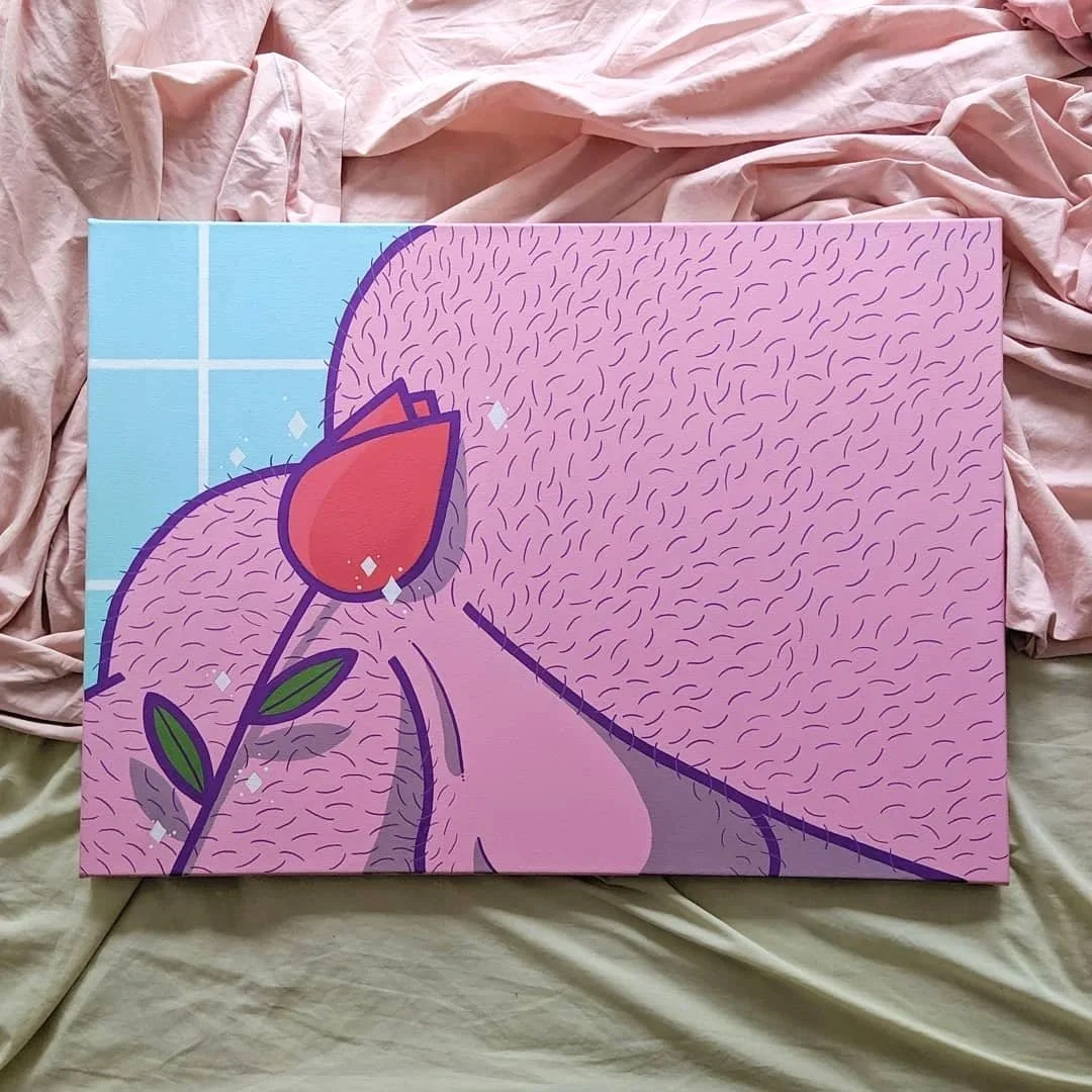 Colorful illustrated artwork of a bear holding a flower on a pink background with lines and sparkles, displayed on wrinkled fabric.