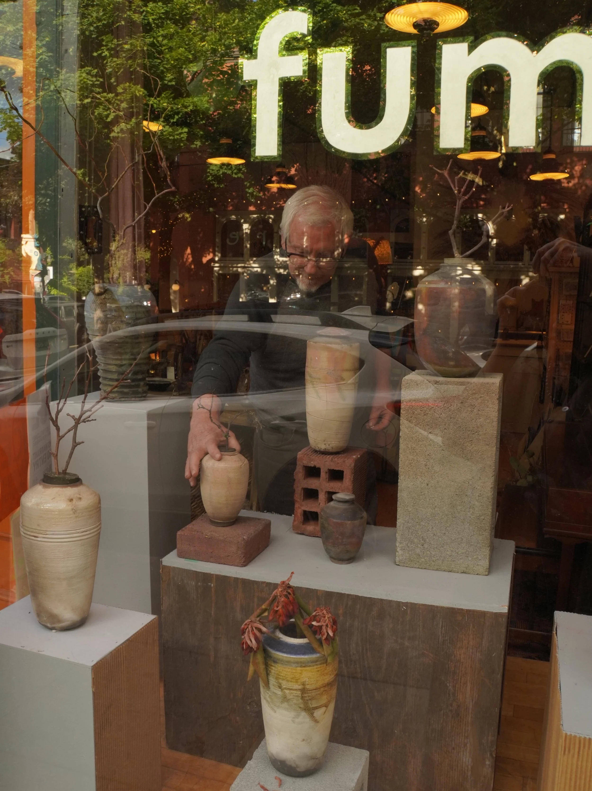 Tim Warner took down Vessels last night. Up for over a month, his raku urns and vases became fixtures in the shop windows. Tim visited often with friends and family, as he lives near by. It was beautiful to witness the community support and love for 