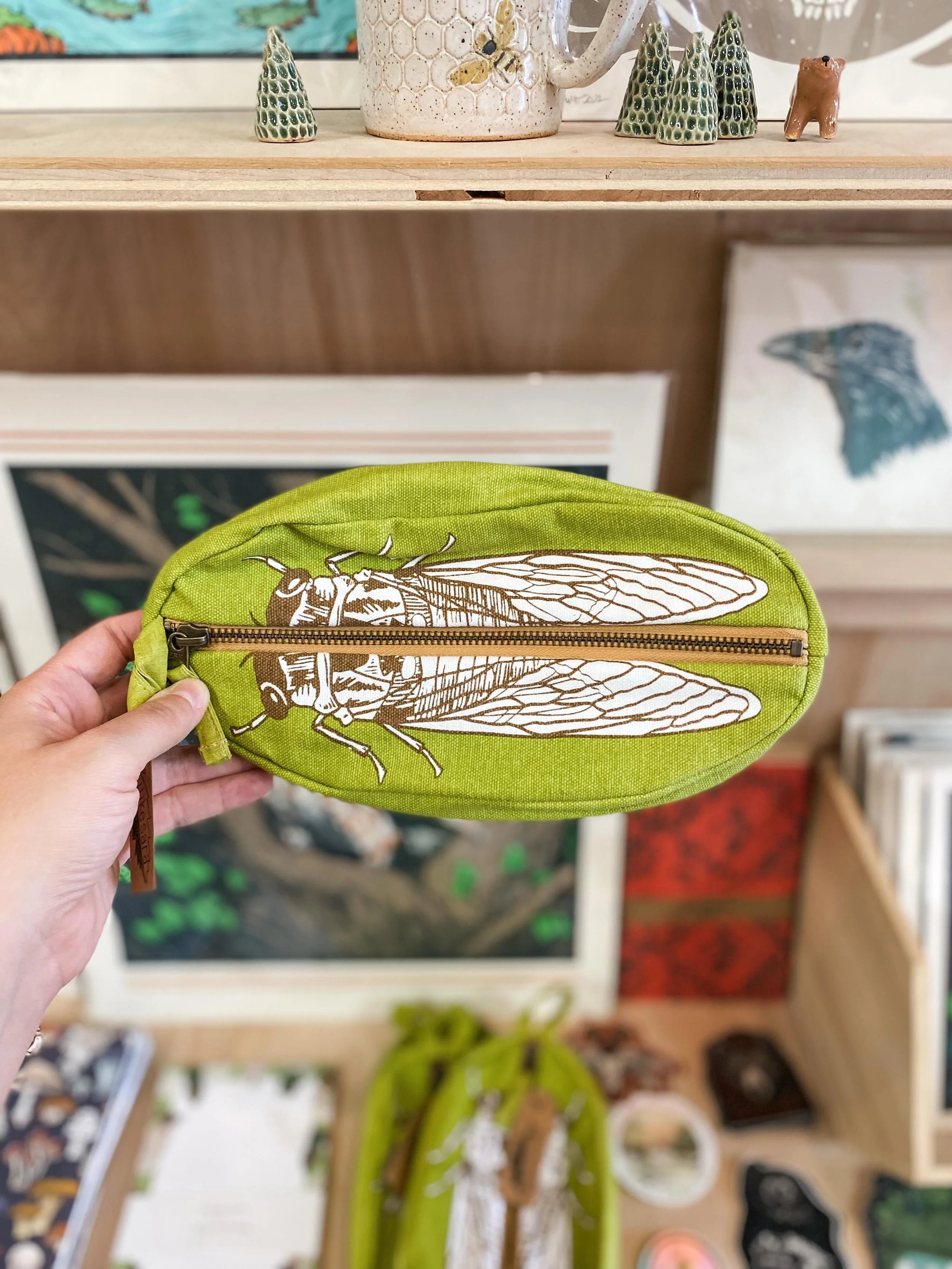 Who doesn&rsquo;t love cicadas?! 🪳 We love these clever pouches from Denver artist, @ilikesara 🙌 We also love her bandanas, stickers, keychains and more - all new in the shop this week!