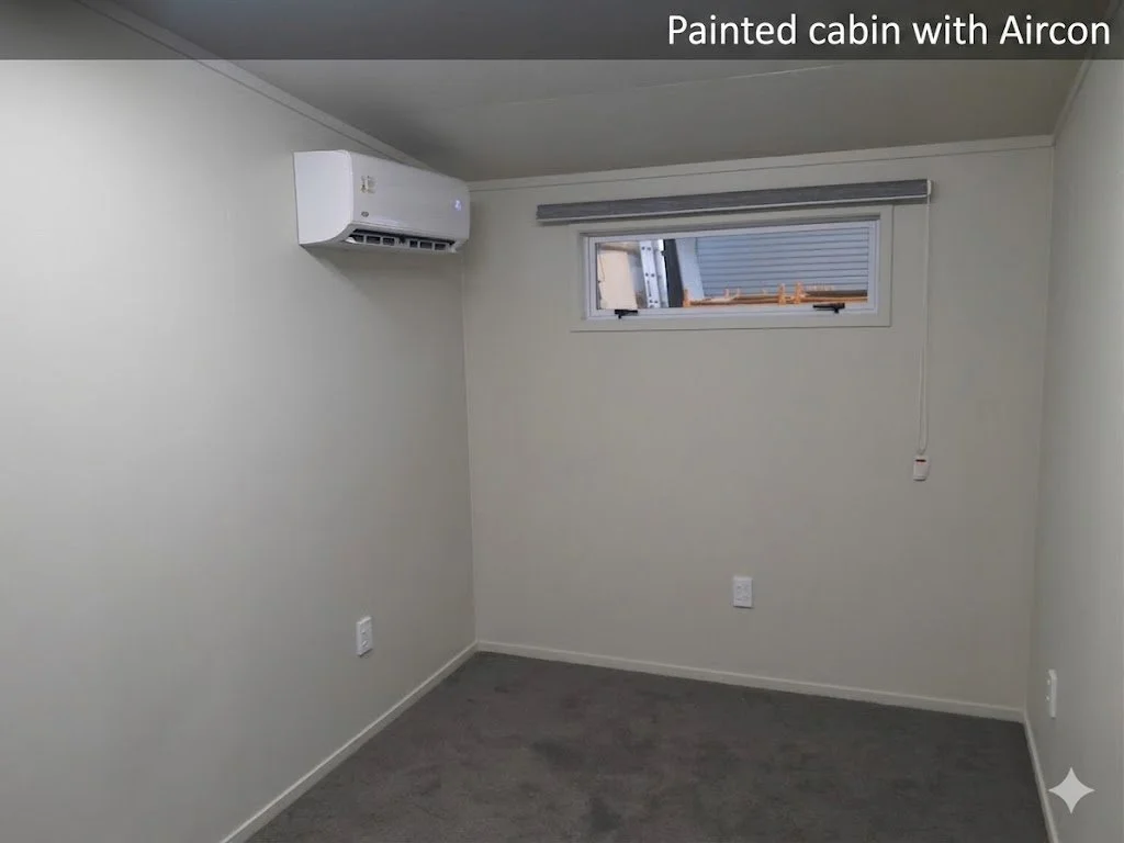 Empty painted room with a window, air conditioner, and a corded remote or switch hanging from the ceiling.
