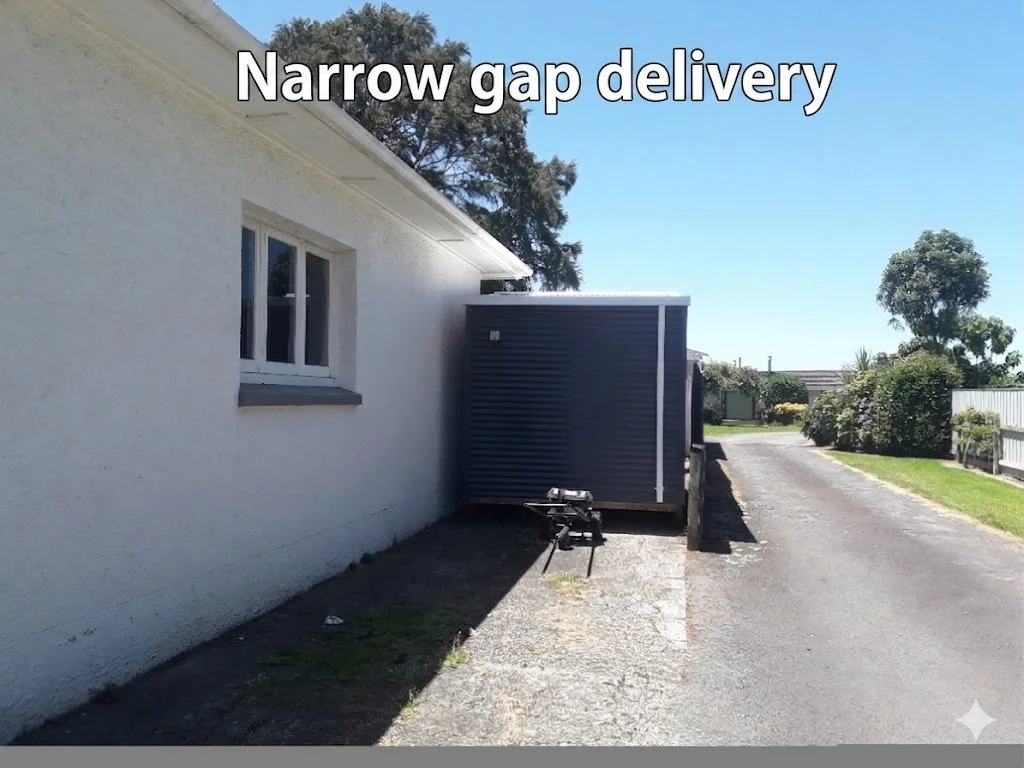 A house with white exterior wall, a small window, a narrow driveway, and a narrow gap delivery container positioned close to the wall. Text overlay says "Narrow gap delivery."